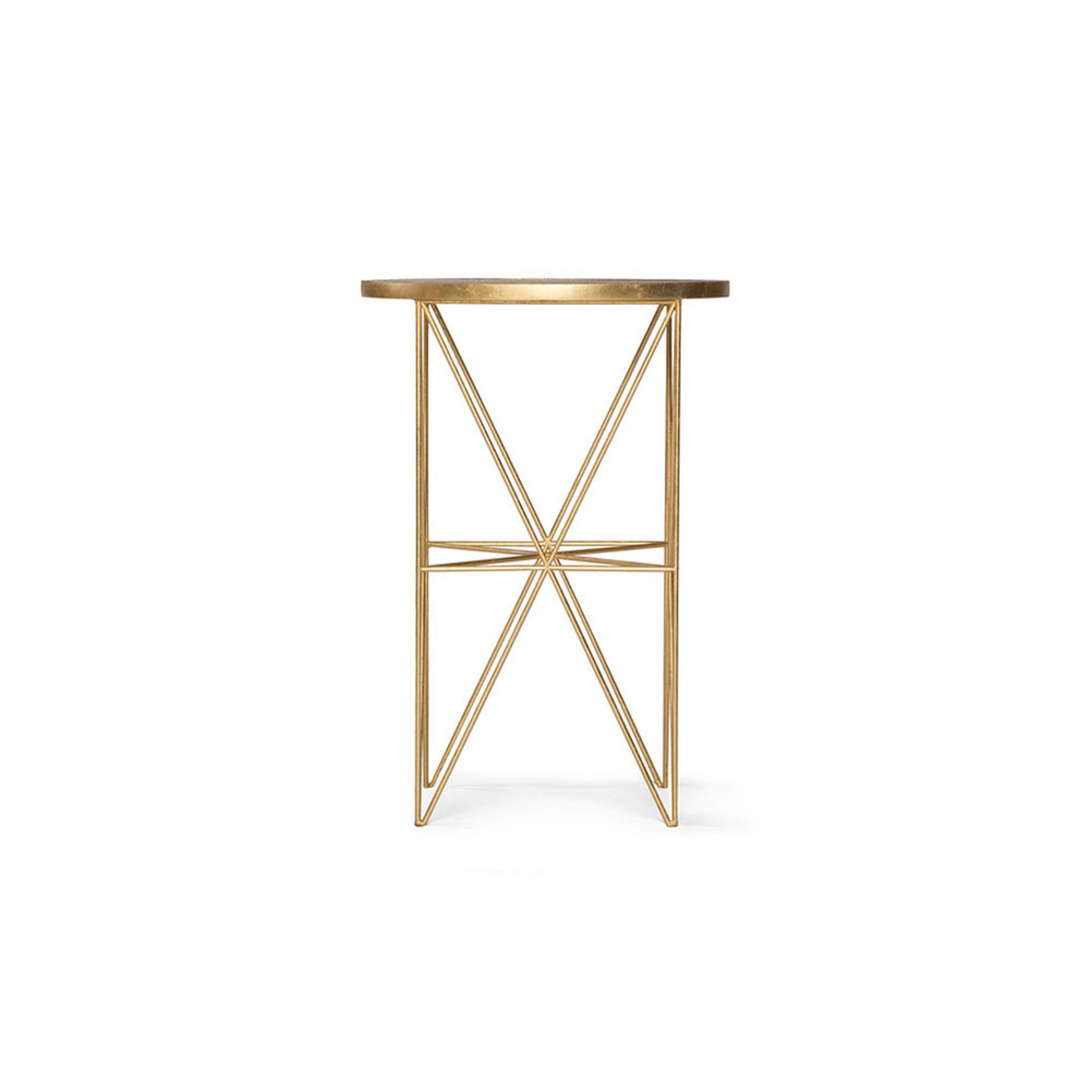 This handmade Monterey tall side table features an intricate hand-gilded metal base and a hand- nished wood top. Elegant and functional, this side table uni es style and aesthetic by adding a touch of Old Hollywood glitz on a hand-gilded geometric