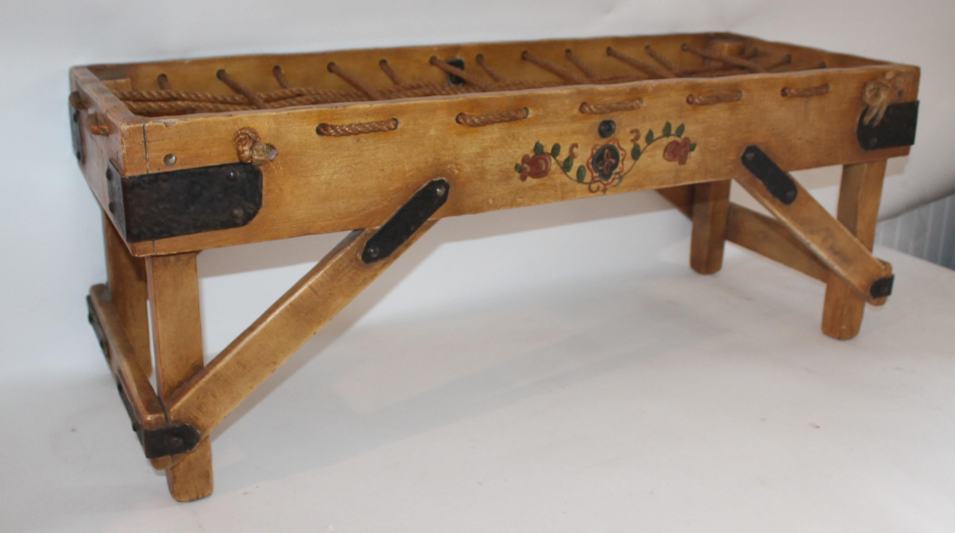 1920-1930s Monterrey bench with straw ivory, hand painted floral design with rope. The forged iron strapping is a hand hammered strapping. This bench is signed Monterrey, circa 1929.
 