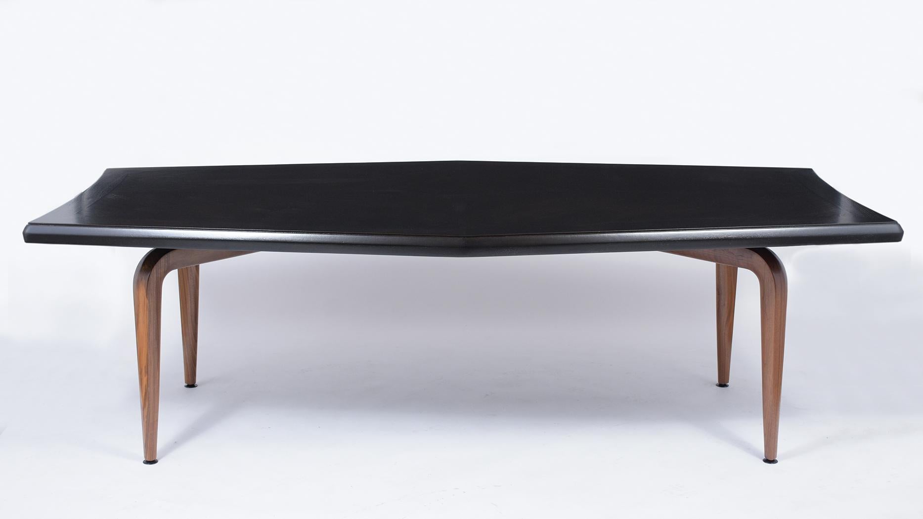 An extraordinary mid-century modern Monteverdi-Young dining table hand-crafted out of walnut wood is finished in a walnut and ebonized color combination with a satin lacquered finish and is fully restored. this executive writing table features a