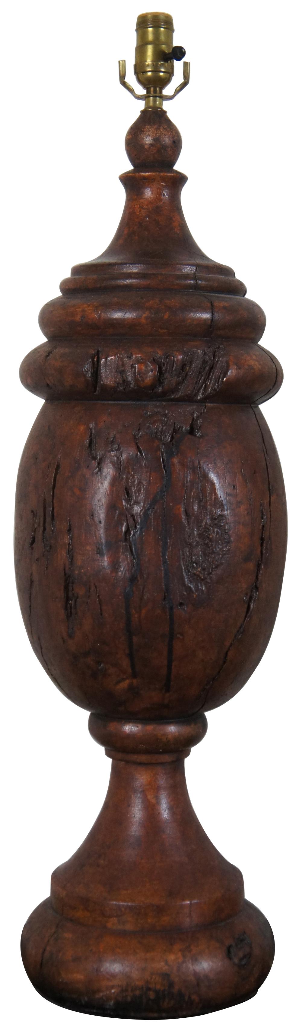 Two oversize table lamps by Monticello Studio, Chicago, marked at the bottom edge with the year, 1998, and 397. Made of ceramic, expertly molded and painted to resemble carved aged wood. Includes white shades and acorn finials.

Measures: 9” x 33”