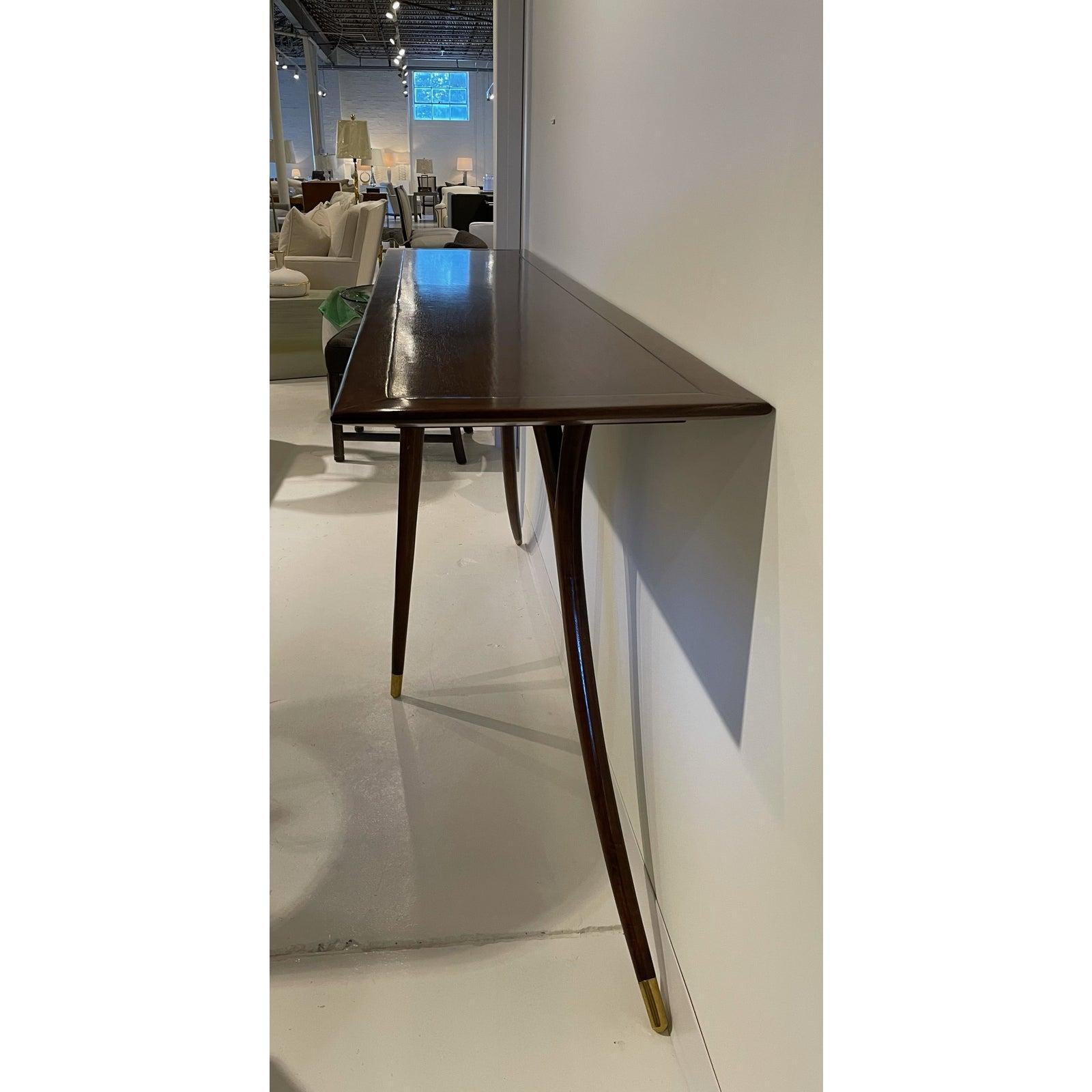 Showroom new - montique mid century console - natural waxed finish walnut with light brass finish metal ferrules. A statement piece in any room of your home or business.
