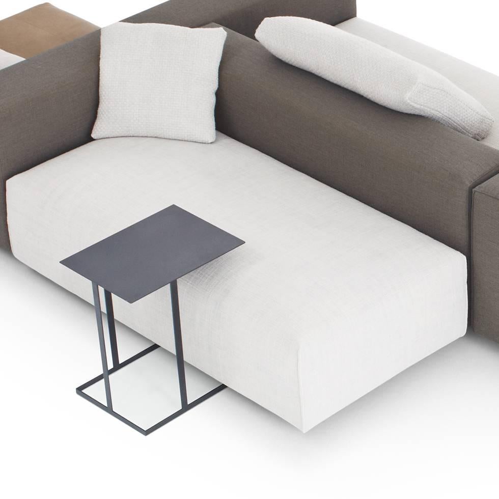 Annex is a multifunctional side table. The support has asymmetrical structures of flat metal strips. The functions of the free tabletop with projection are obvious and are ideal for working from the couch or lounge chair with a laptop, for putting