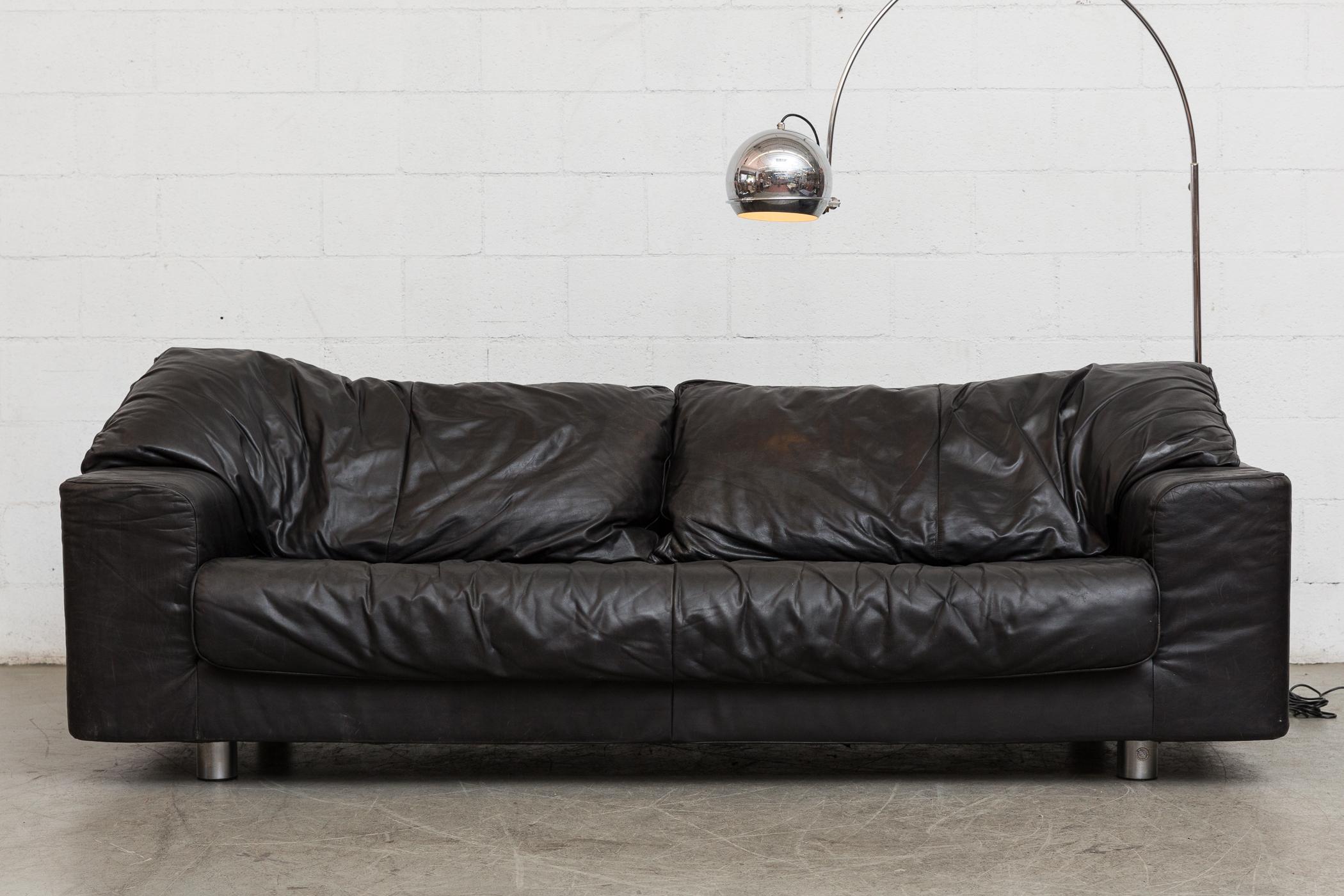 Large comfy midcentury three-seat sofa in black leather. Designed by Gerard Van Den Berg for Montis. Zip on back cushions four short chrome legs. Original manufacturer tag photographed. Good original condition. Set price.