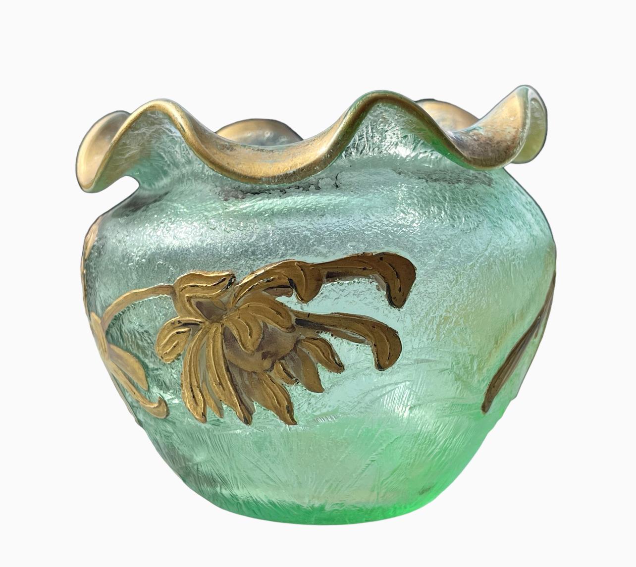 Small ball vase with wavy neck in enameled glass with acid-etched floral decoration. Enhanced with gold on an opalescent sea green background, this vase is in perfect condition.

Dimensions
Height 8.5cm
Diameter 10cm