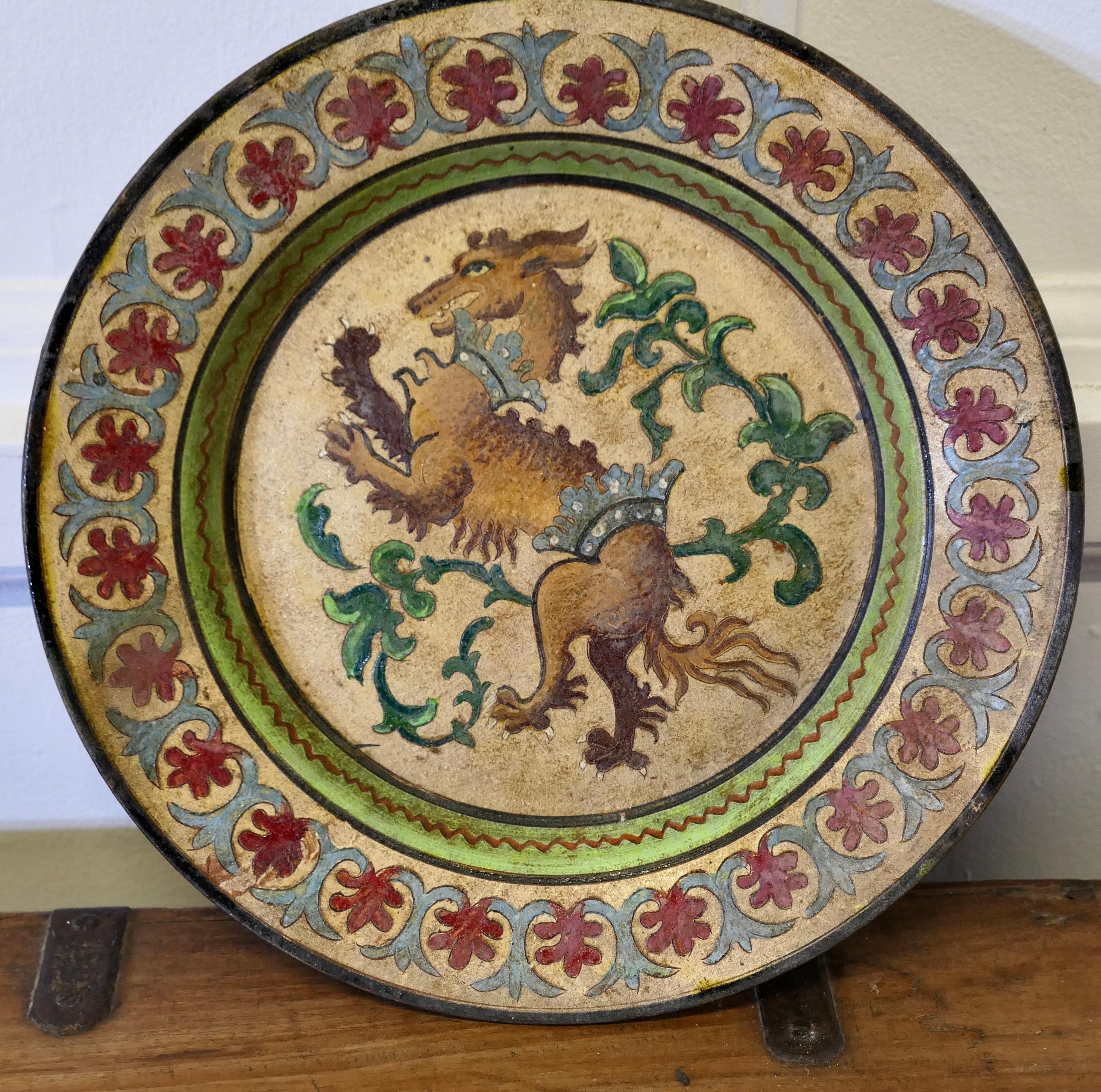 Montopoli Arno Italian Plate with a Lion

An unusual piece made in terracotta marked Montopolyi Arno, the plate is a very attractive piece relief decorated with a Lion like creature
In sound condition the plate is 12” in diameter
ZX94
