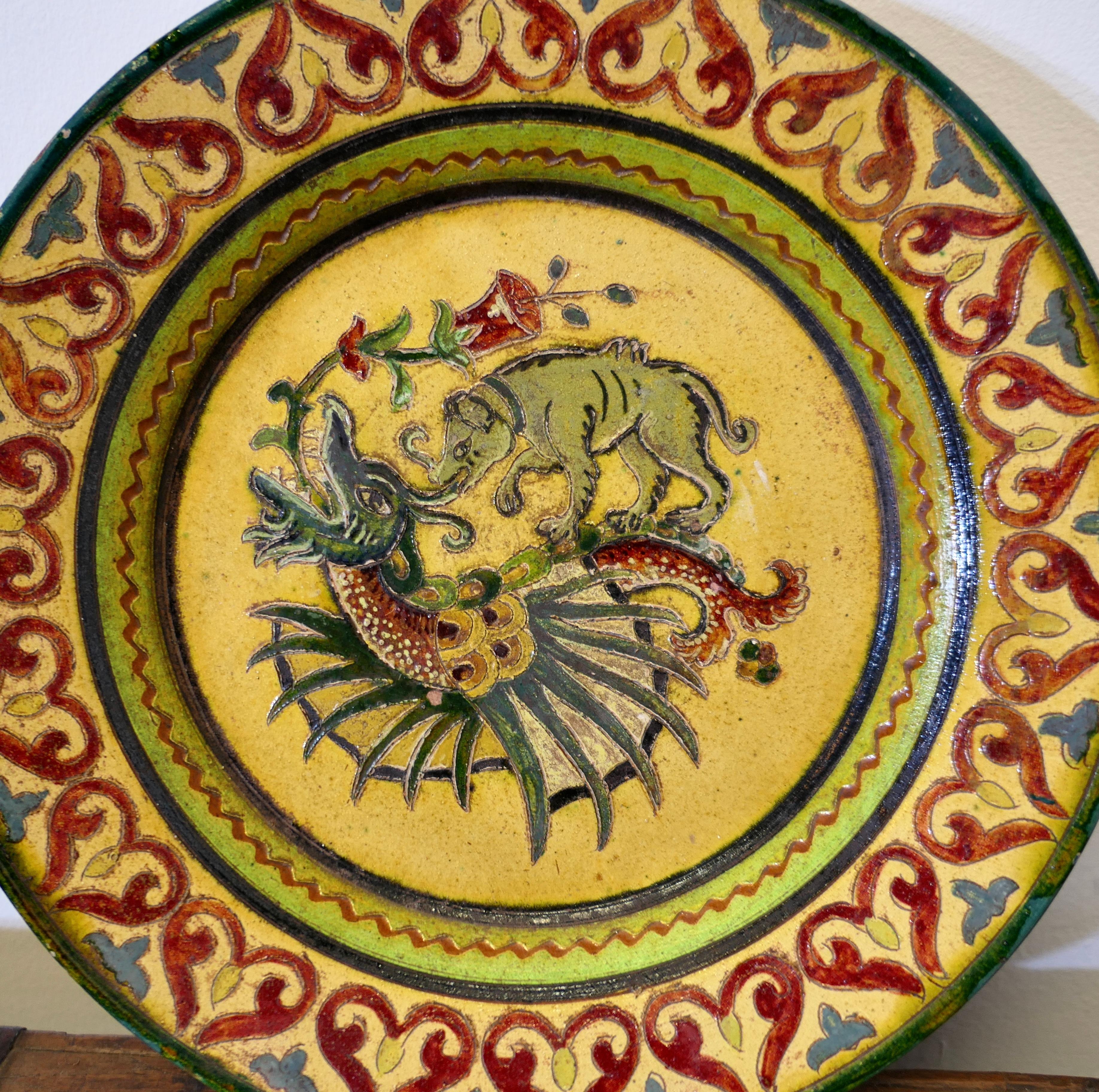 Montopolyi Arno Italian Plate with Dragon and Bear

An unusual piece made in terracotta marked Montopolyi Arno, the plate is a very attractive piece relief decorated with plants, a bear like creature and a flying creature 
In sound condition the