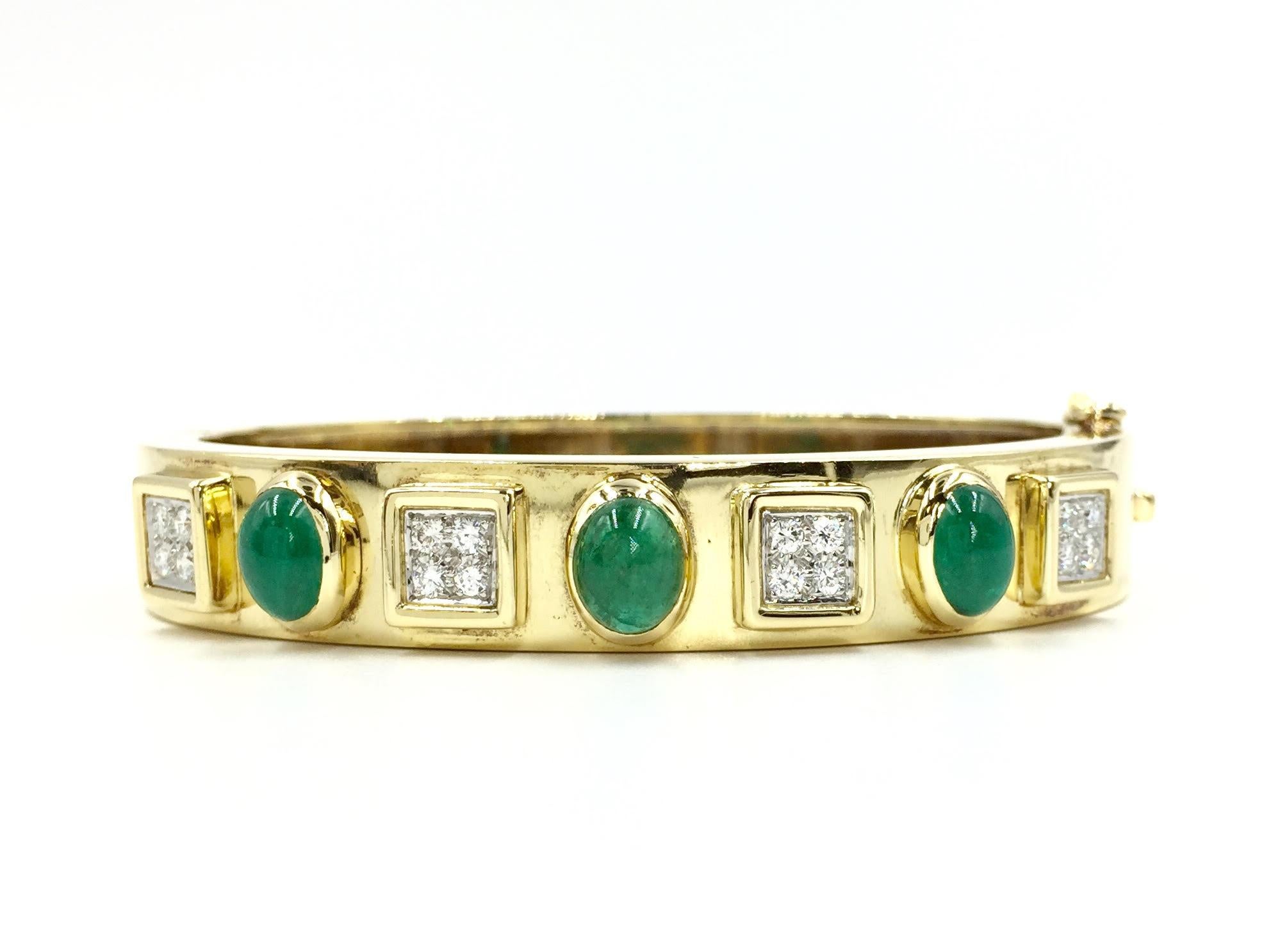 Created in 1981 by Montreaux jewelry. Fashionable 18 karat yellow gold polished oval bangle featuring three gorgeous genuine oval cabochon emeralds with a total weight of 3.28 carats. Sixteen high quality round brilliant diamonds are set in square