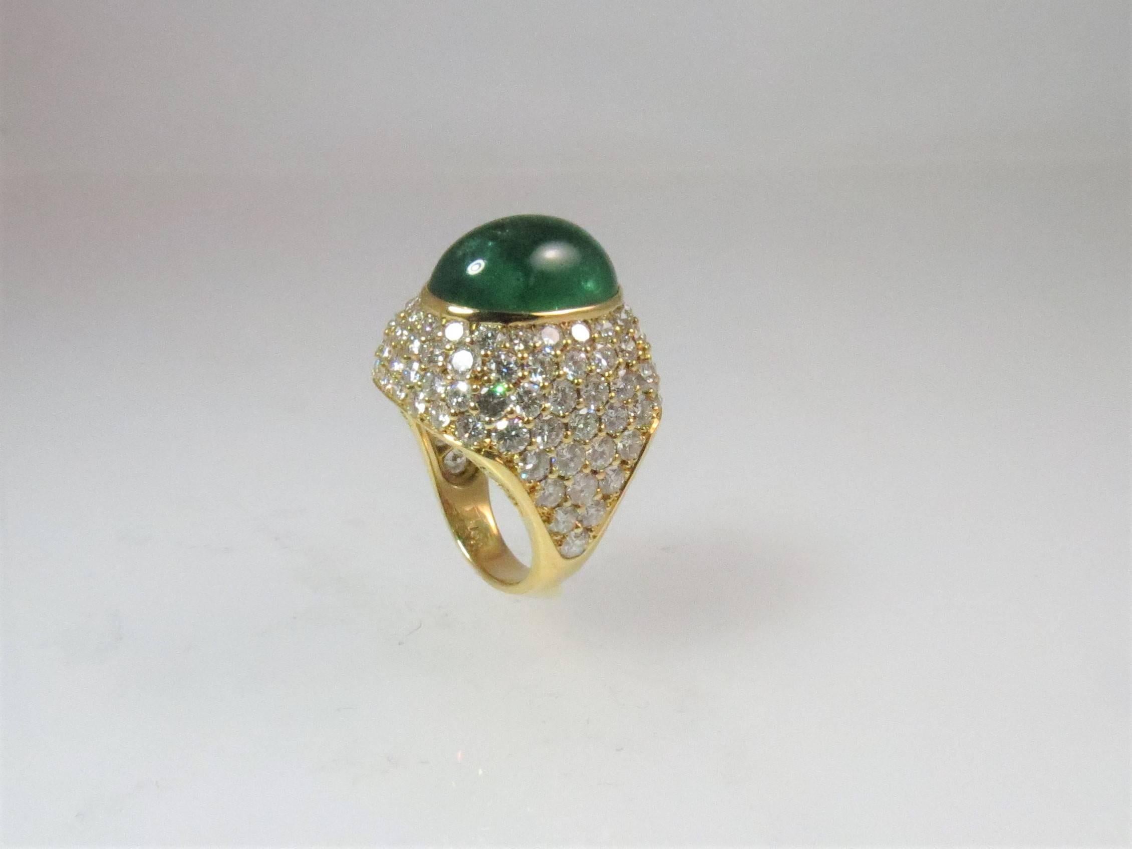 Montreaux 18K yellow gold ring, with 124 full cut round diamonds set in platinum, weighing 8.31cts, D-E color, IF-VS clarity, set in center with one Cabochon emerald weighing 13.01cts
Finger size 6, may be sized.