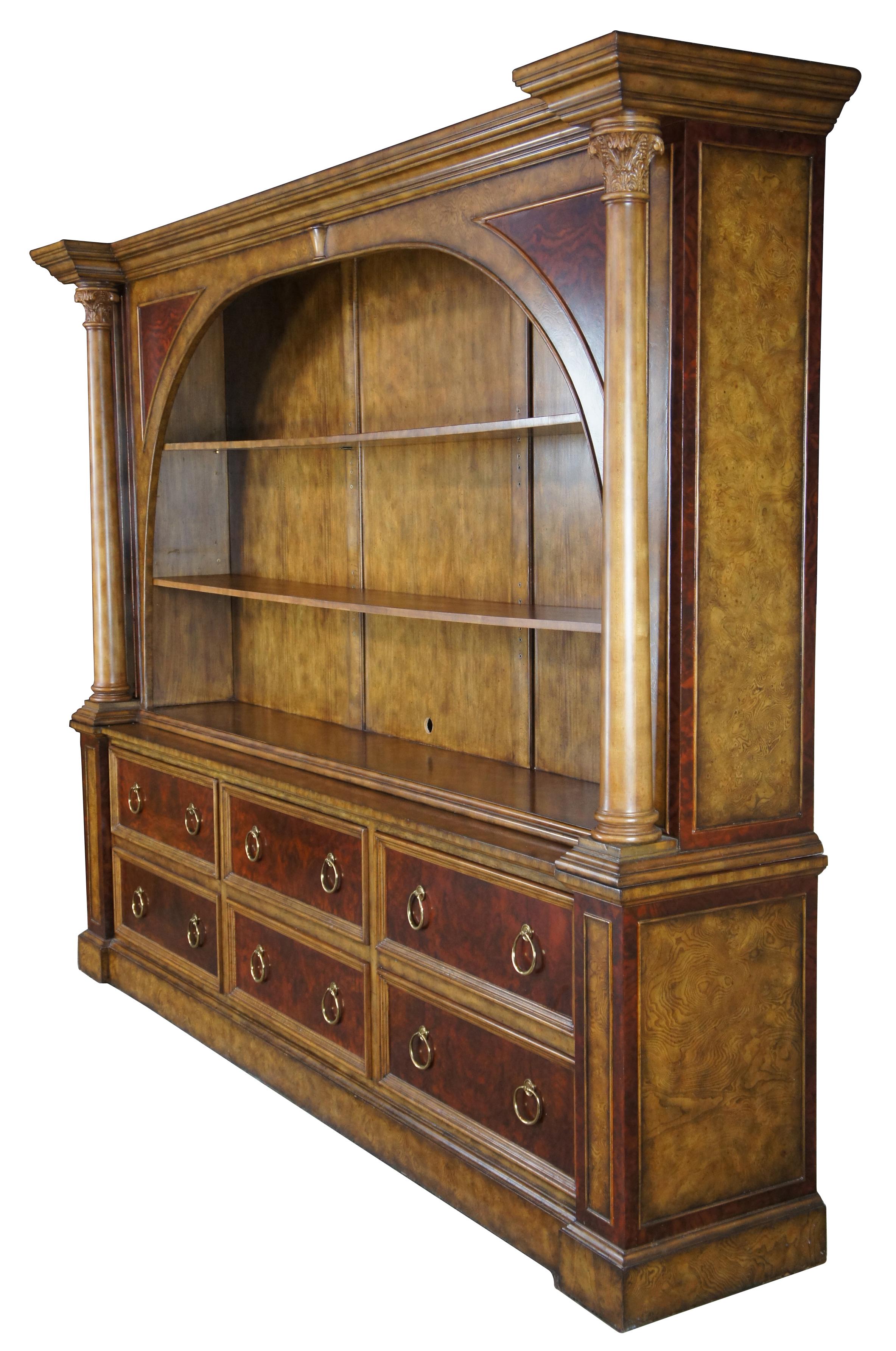 Neoclassical inspired bookcase by Maitland Smith. Features two concealed shelves behind and arched front with columns. Lower half includes six drawers with knocker pulls. Made from mahogany with burled ash. Measures: 110”.
  