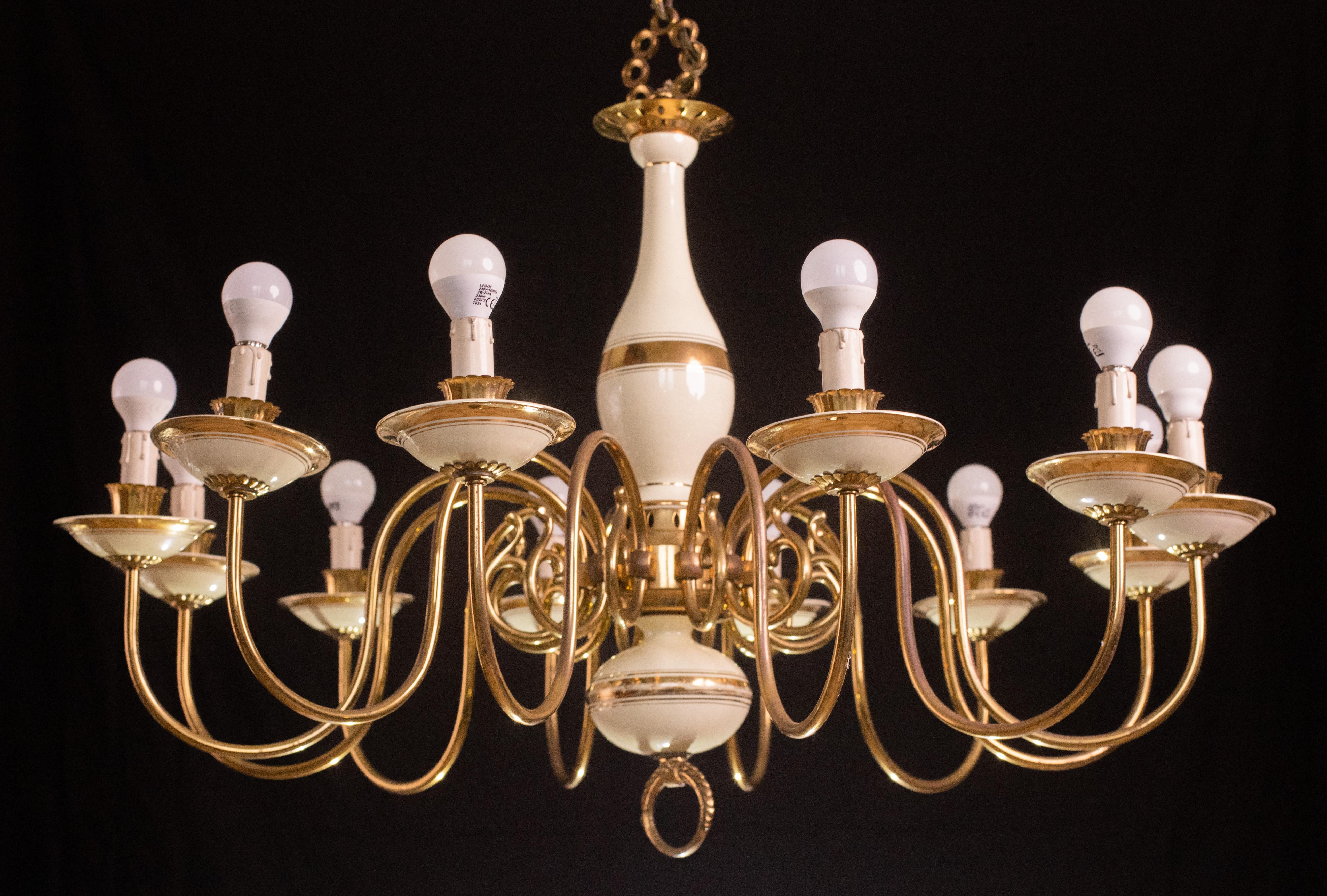 Gorgeous Art Deco chandelier in brass and painted terracotta.

The 12 light points mount a standard European socket and 14.