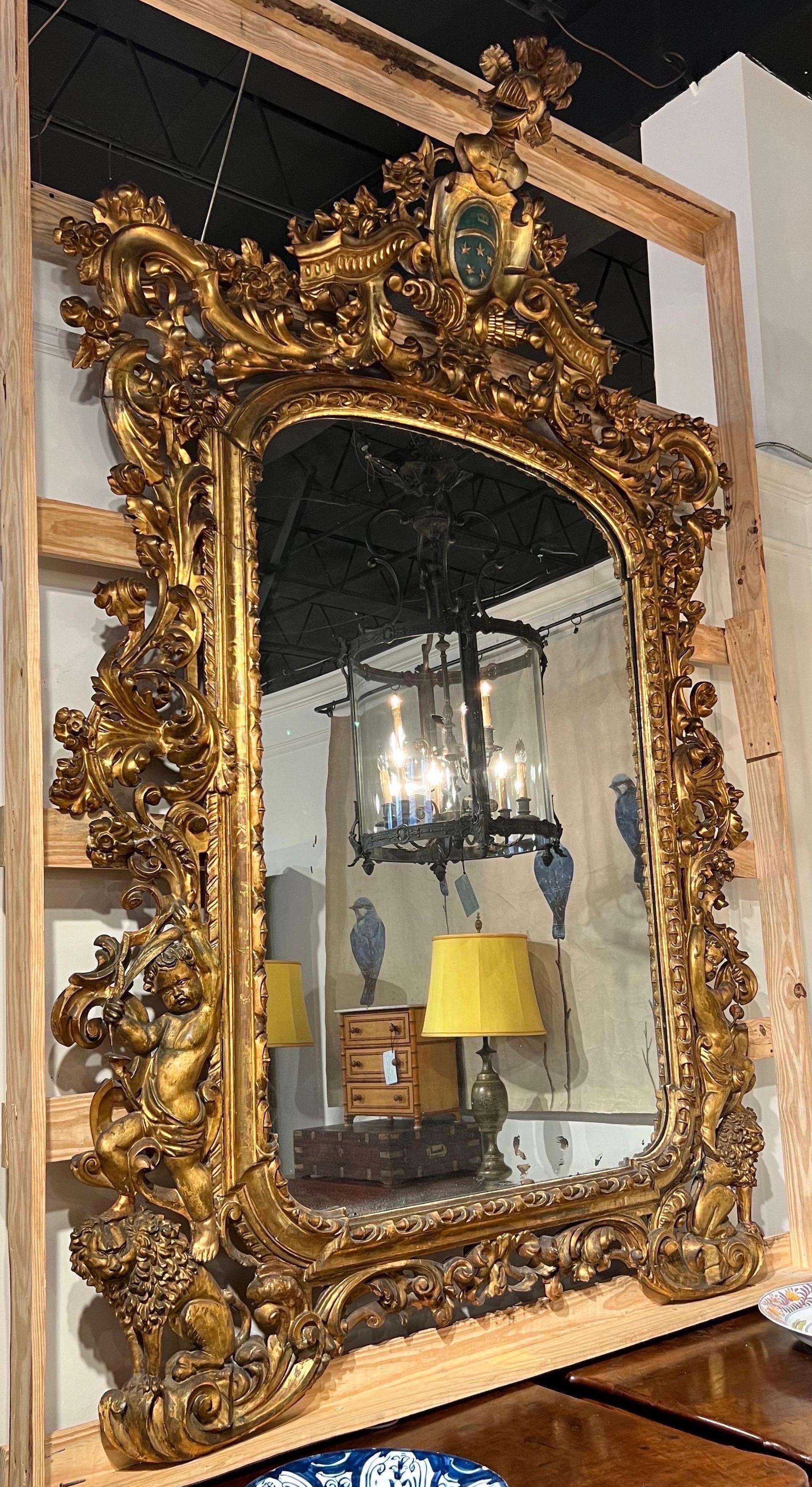 European Monumental 18th-19th century Giltwood mirror with coat of arms  For Sale