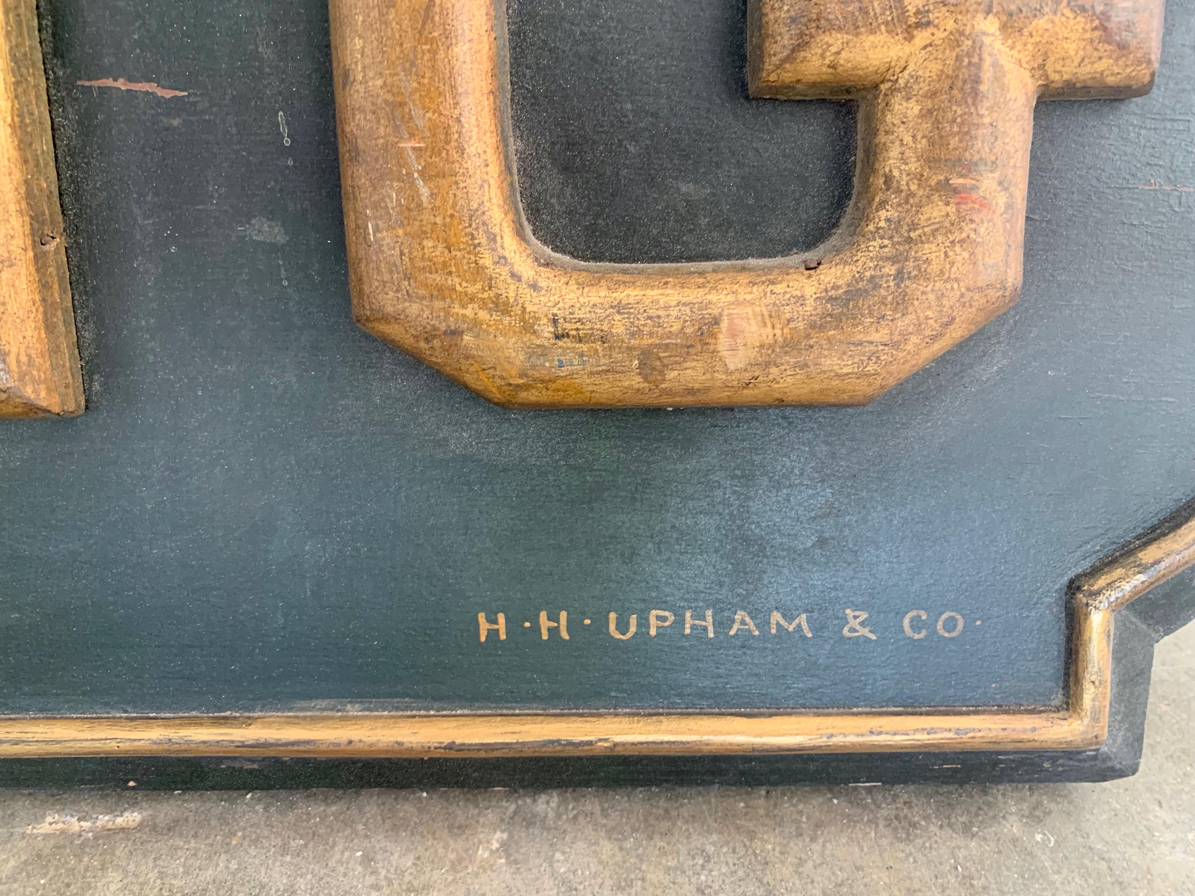 Monumental hand carved wood sign from the 1930s. Made by H.H. Upham & Co. Interestingly, this company owned a huge sign manufacturing business in the city and owned the building they worked out of. Great period piece. Black sign with hand painted
