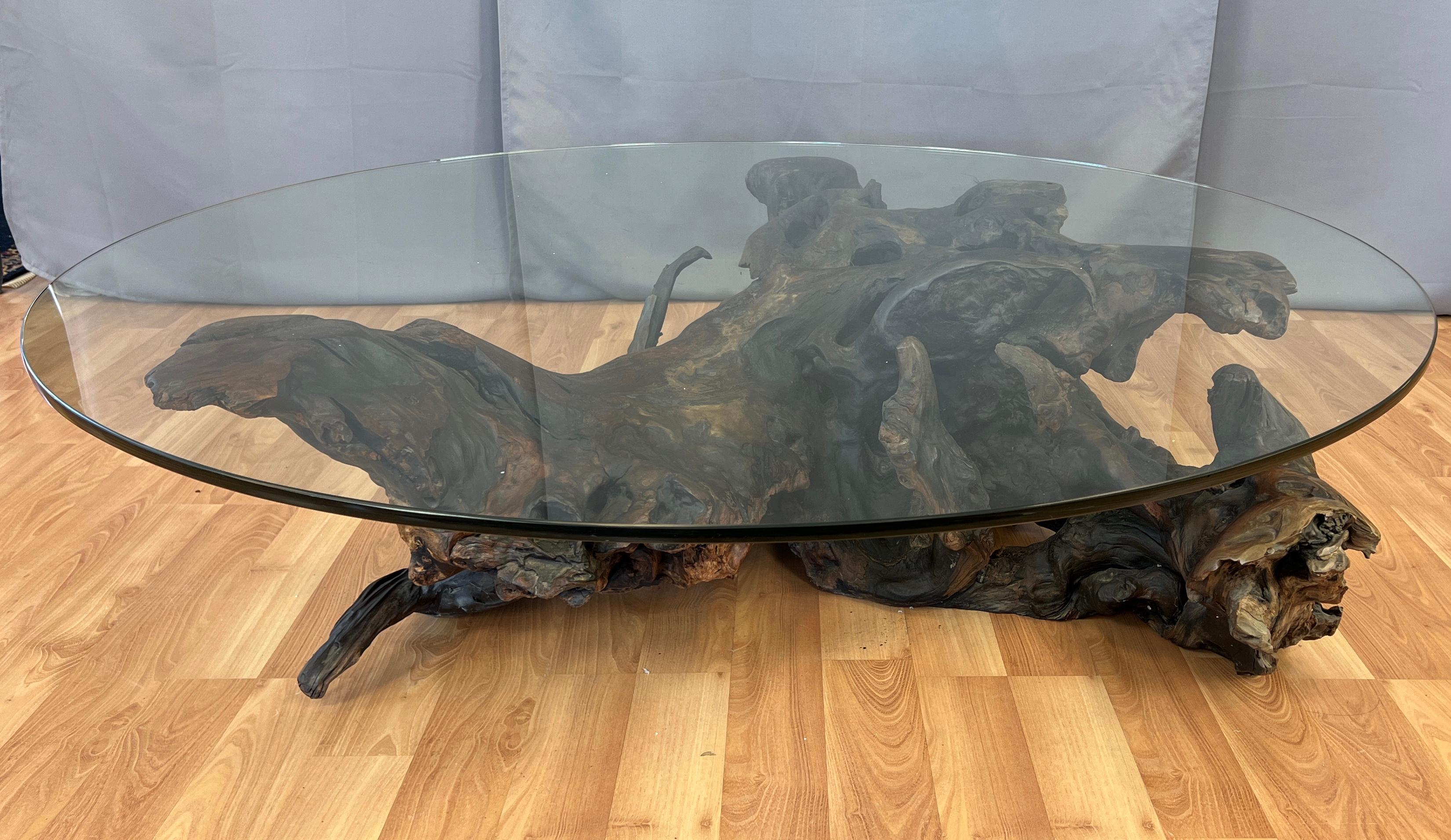 Offered here is a monumental in size, circa 1970s natural freeform wooden base with a round glass top coffee table.
We believe the base is redwood, with the wood looks to be flowing out from it's center like waves on the ocean.
Wonderful grains,