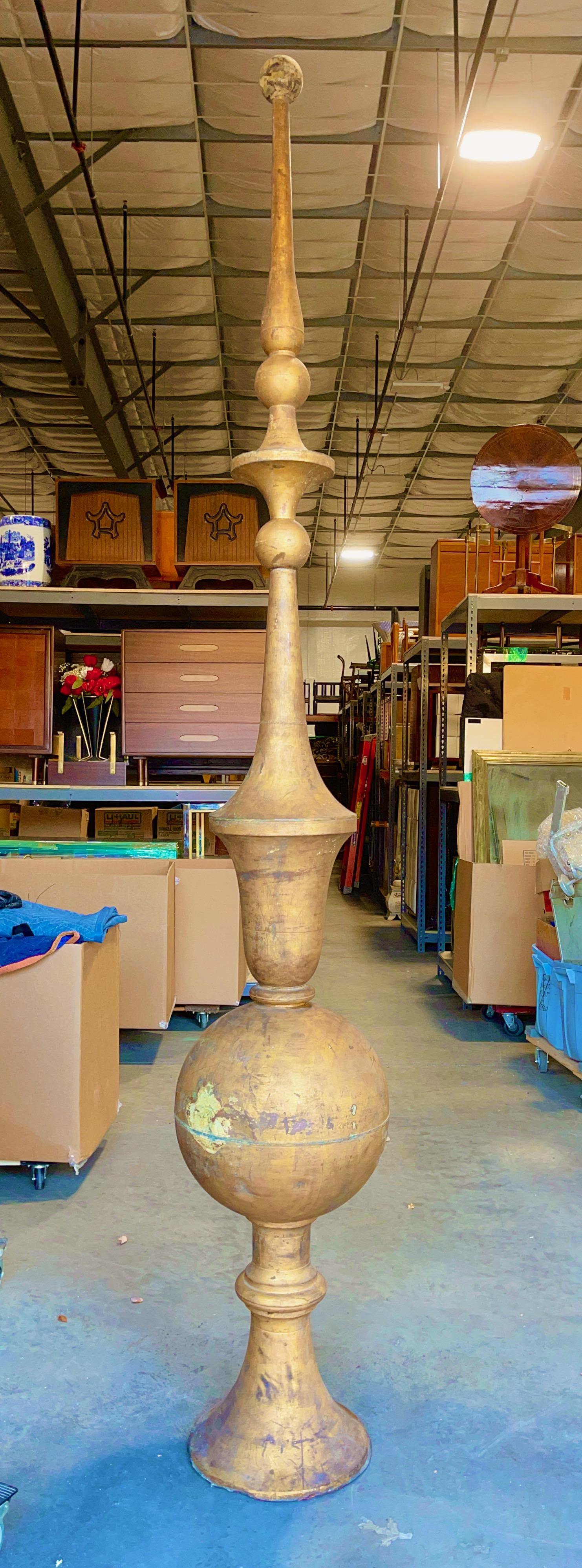 Extraordinary architectural roof finial spire over 9 feet high constructed of hand beaten copper then finished in gold leaf.
Looking for a statement piece? You've found it!
Weighs under 75 pounds.  Stands steady on its own. In two pieces: the top