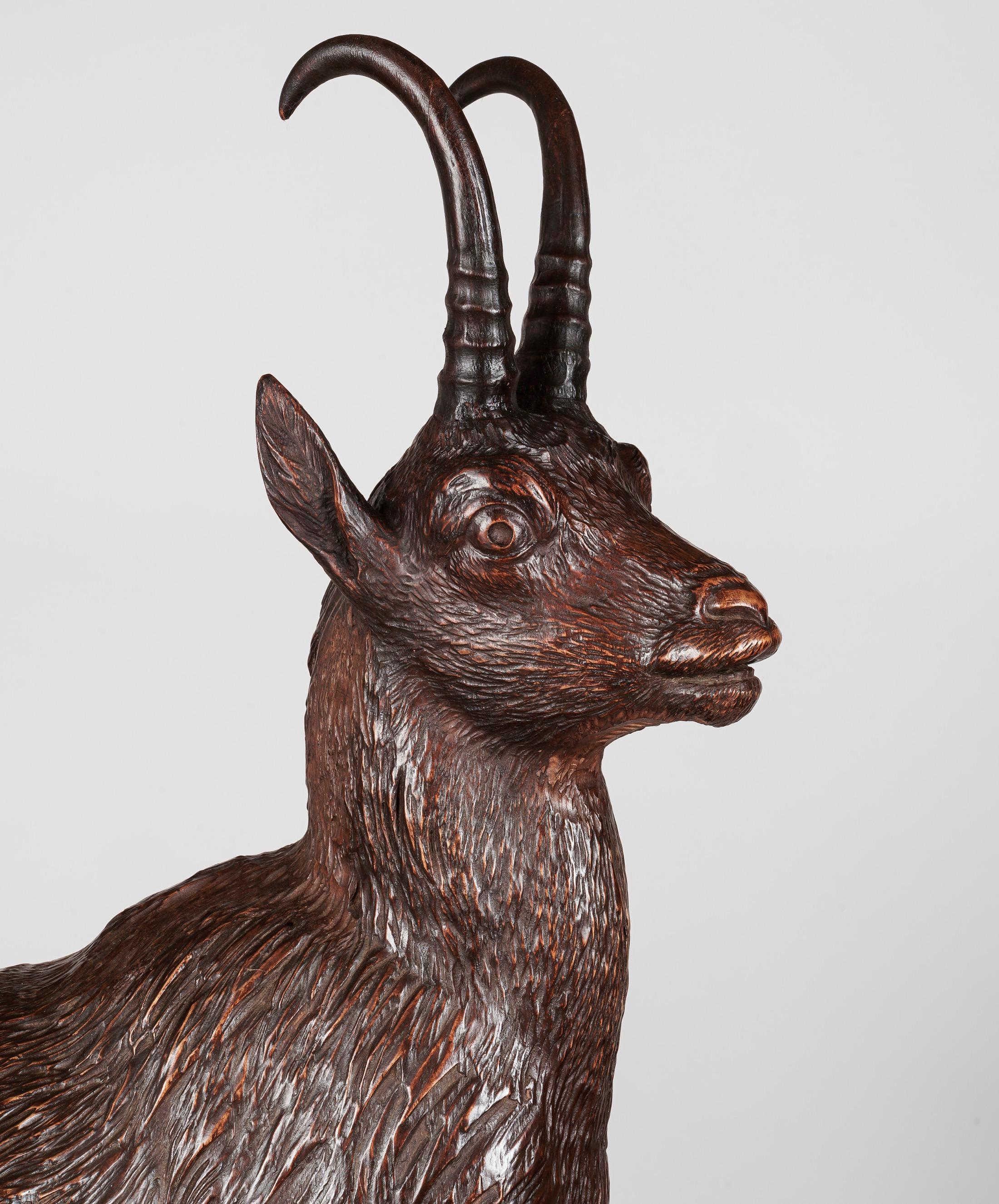 An exhibition-quality 'Black Forest' carving of Chamois

Carved from mature Lindenwood, the family of Alpine Chamois on the lookout, perched on a naturalistically carved tree trunk and rocky outcrop, the composition towering nearly 2 meters; the