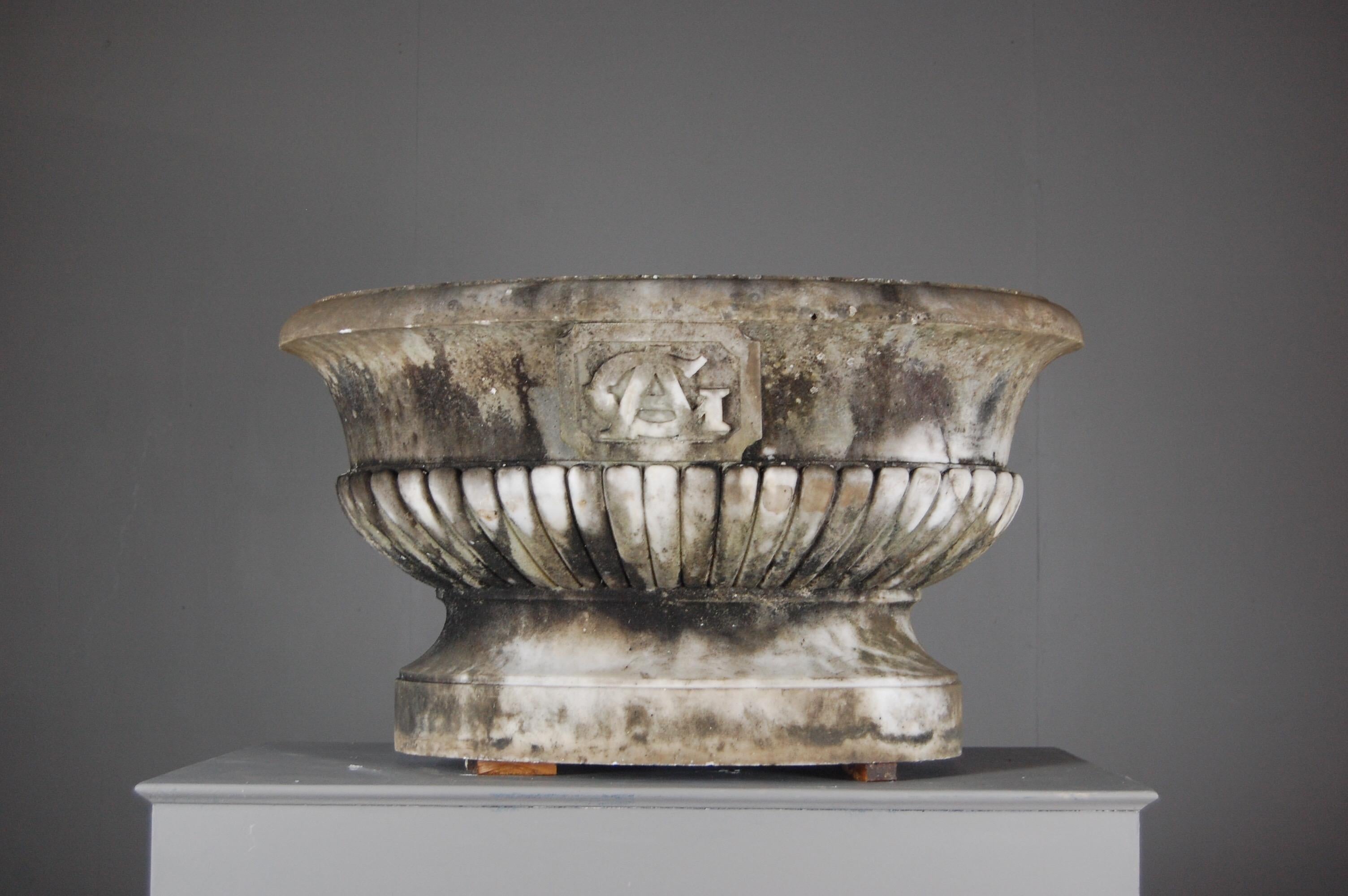 Wonderful scale 19th century Classical carved marble Urn, decorative gadroon carving to the bowl, expected weathering and patina throughout. Originating from Burgundy with the family initials or crest carved the entwined letters GA.
Dimensions: