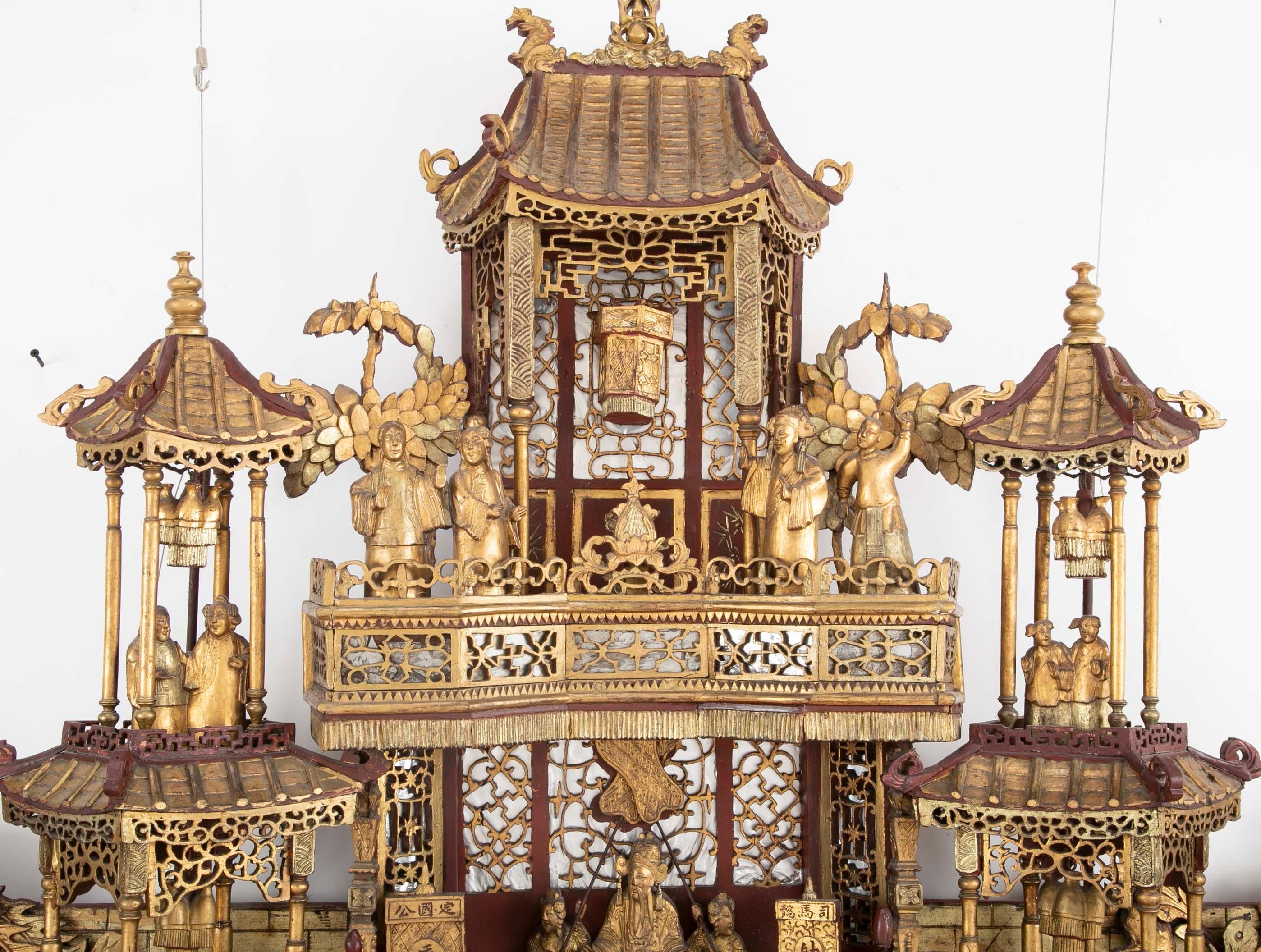 An exquisitely carved monumental 19th century altar piece with three dimensional carving including moving parts.