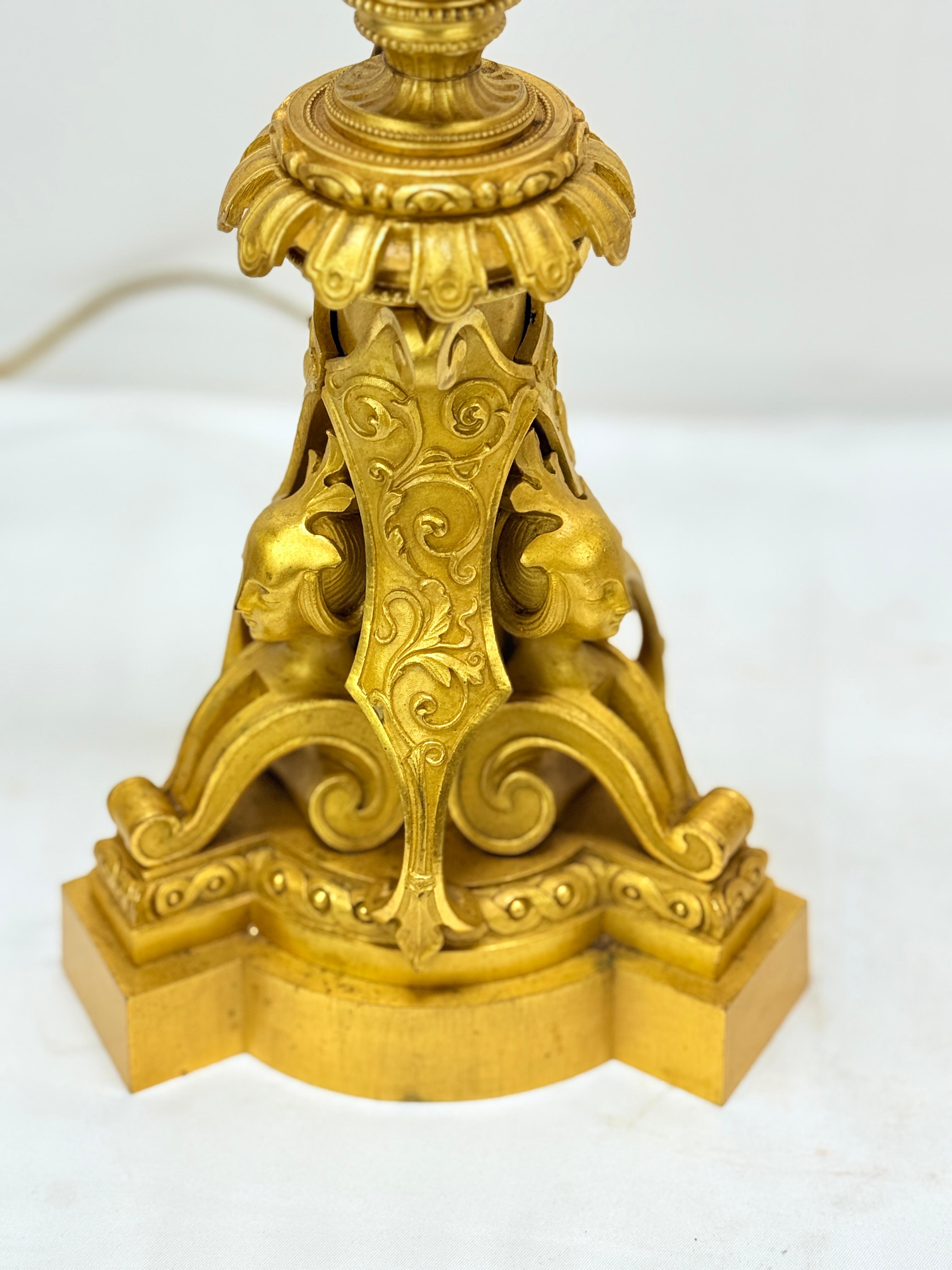 A superb and intricately crafted pair of French gilt bronze candelabras, dating to the 19th century, exemplifying the grandeur and sophistication of the Egyptian Revival aesthetic. These monumental works of decorative art display a masterful