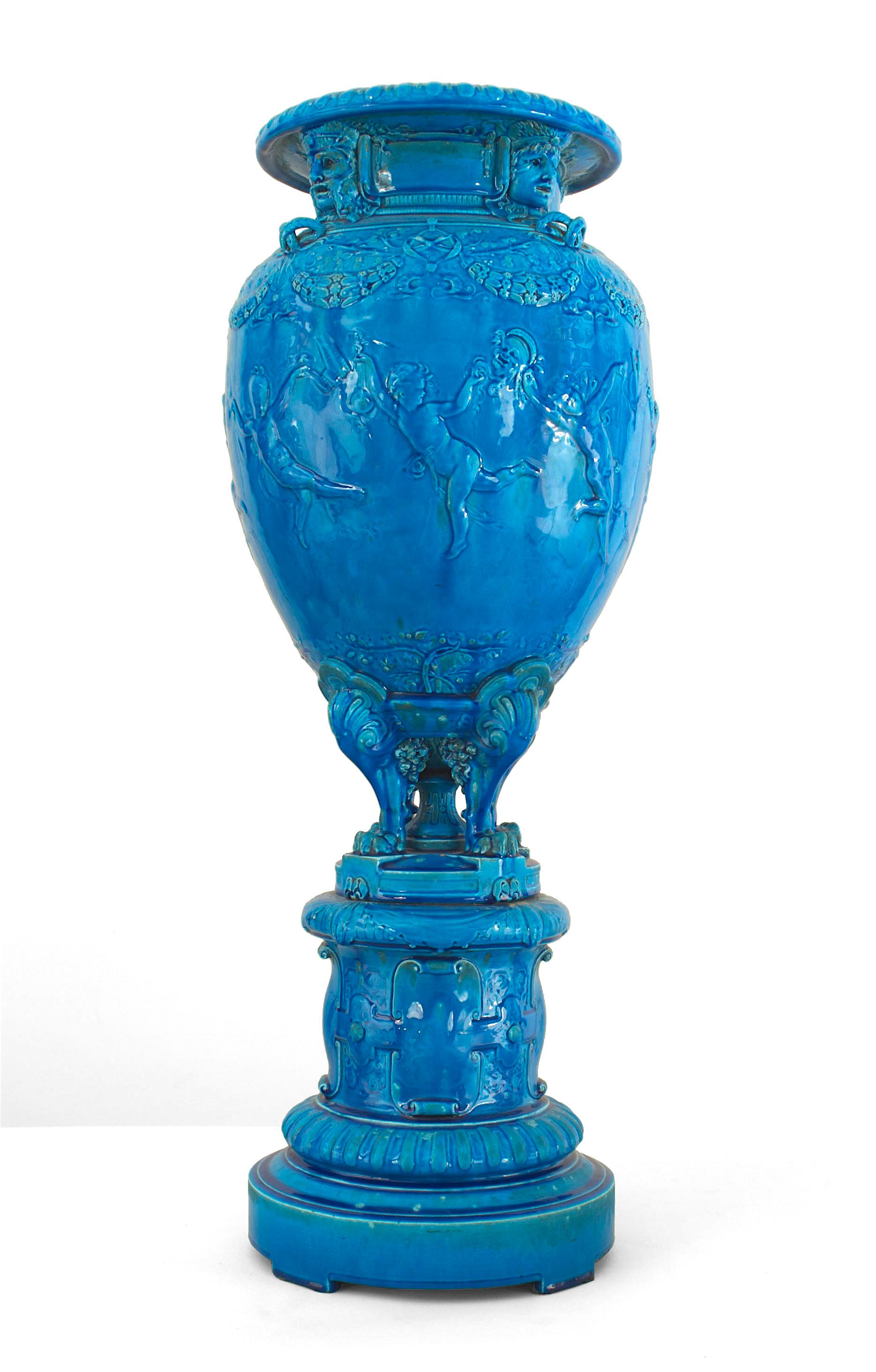 French Victorian monumental turquoise Sevres porcelain vase with cupids in relief on round pedestal base (signed JOSEPH CHERET)
