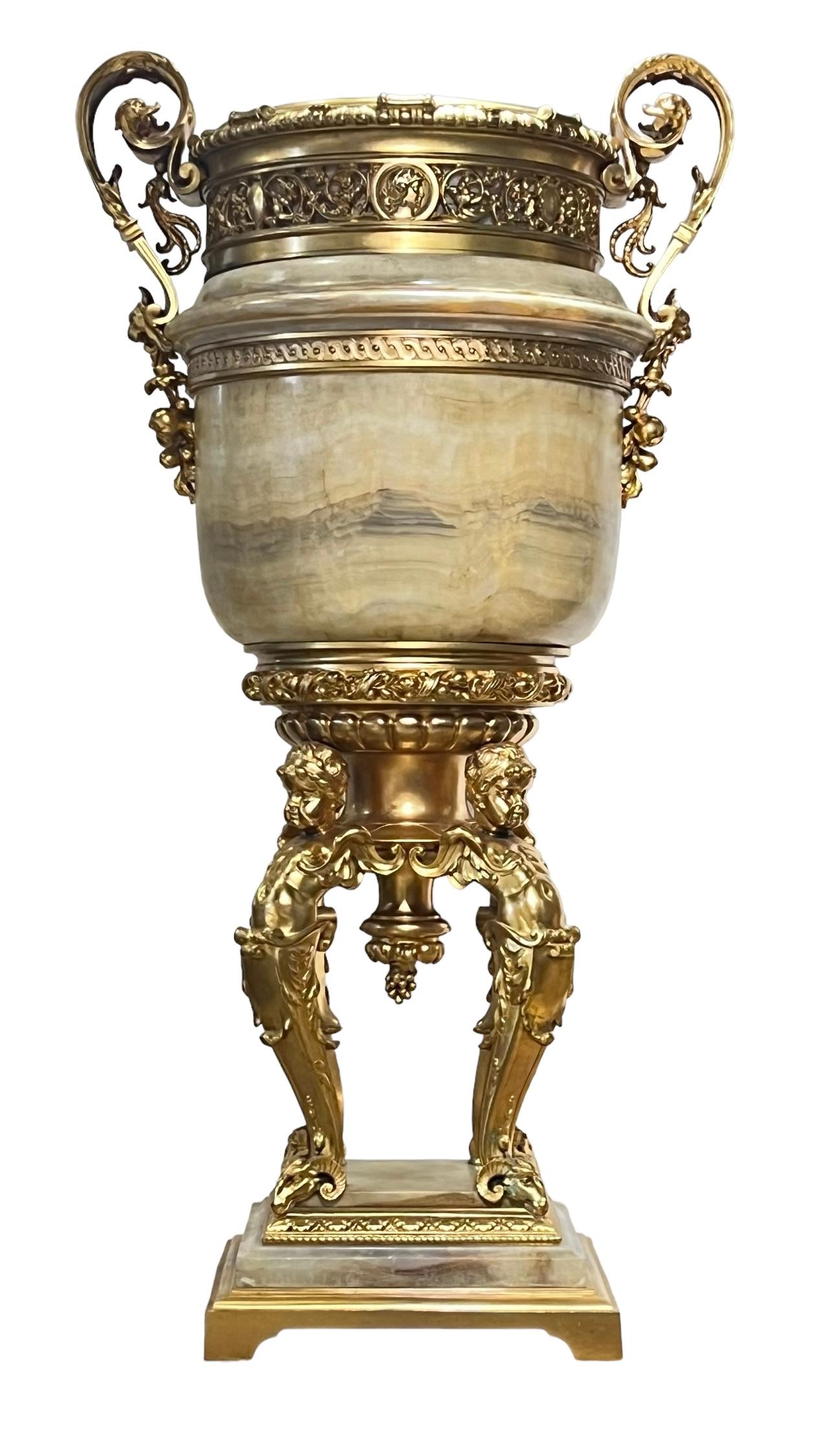 Palatial neoclassical onyx floor vase with gilt bronze mounts of the finest quality in the Louis XVI style, measuring 45.5 in (115 cm) tall.  Excellent condition.  Crafted in three sections.