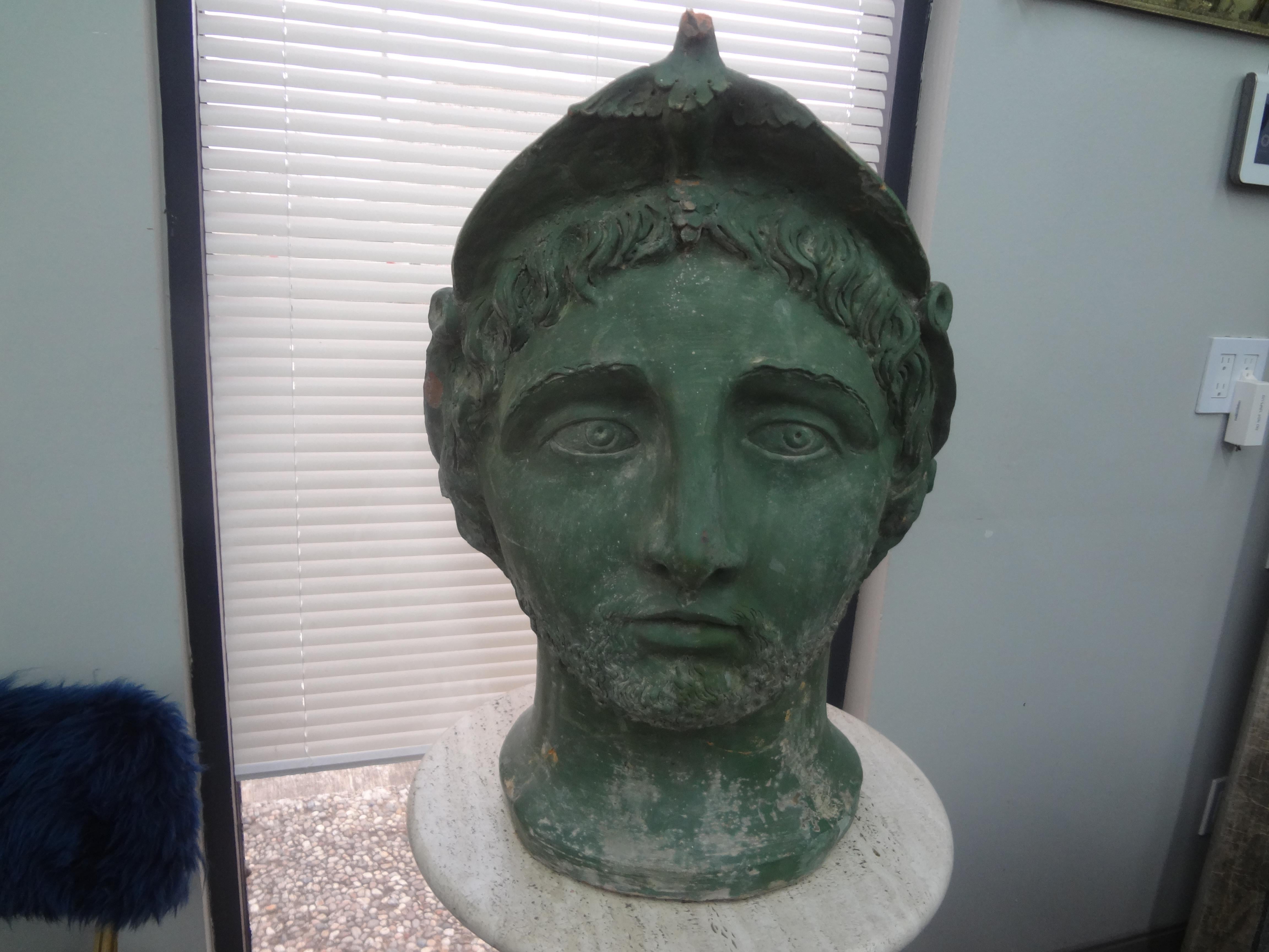 Monumental 19th century Italian patinated terracotta bust.
This stunning mid-19th century Italian terra cotta bust sculpture of a Classical Greek is patinated a lovely shade of green which resembles bronze.
Our statement bust would look great on a