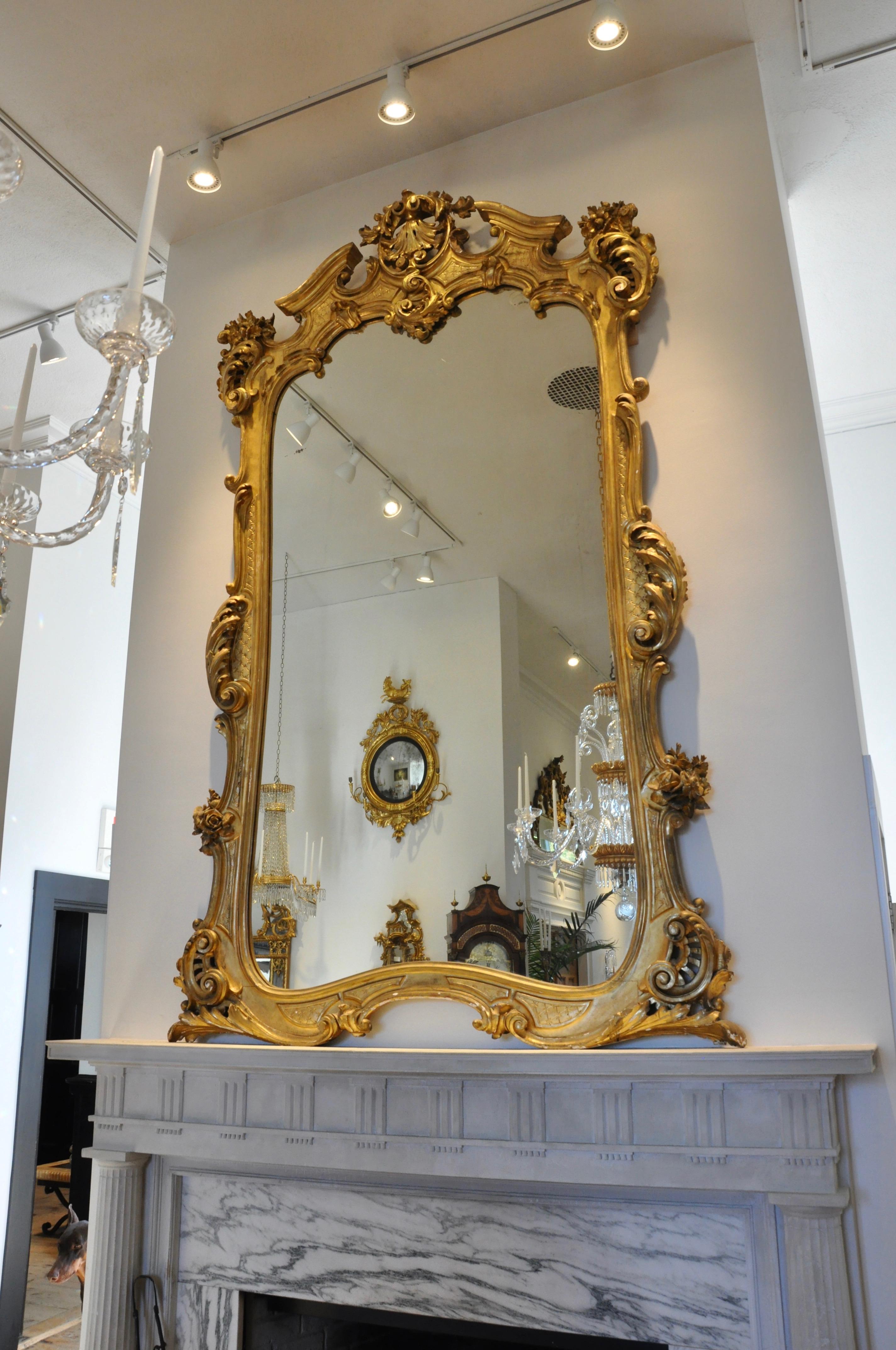 Large-scale 19th century giltwood pier or overmantle mirror

Louis XV style mid-19th century carved and gilt overmantle or pier mirror. Original glass and original gilding. Massive in proportion beautiful neoclassical foliate and floral carving.