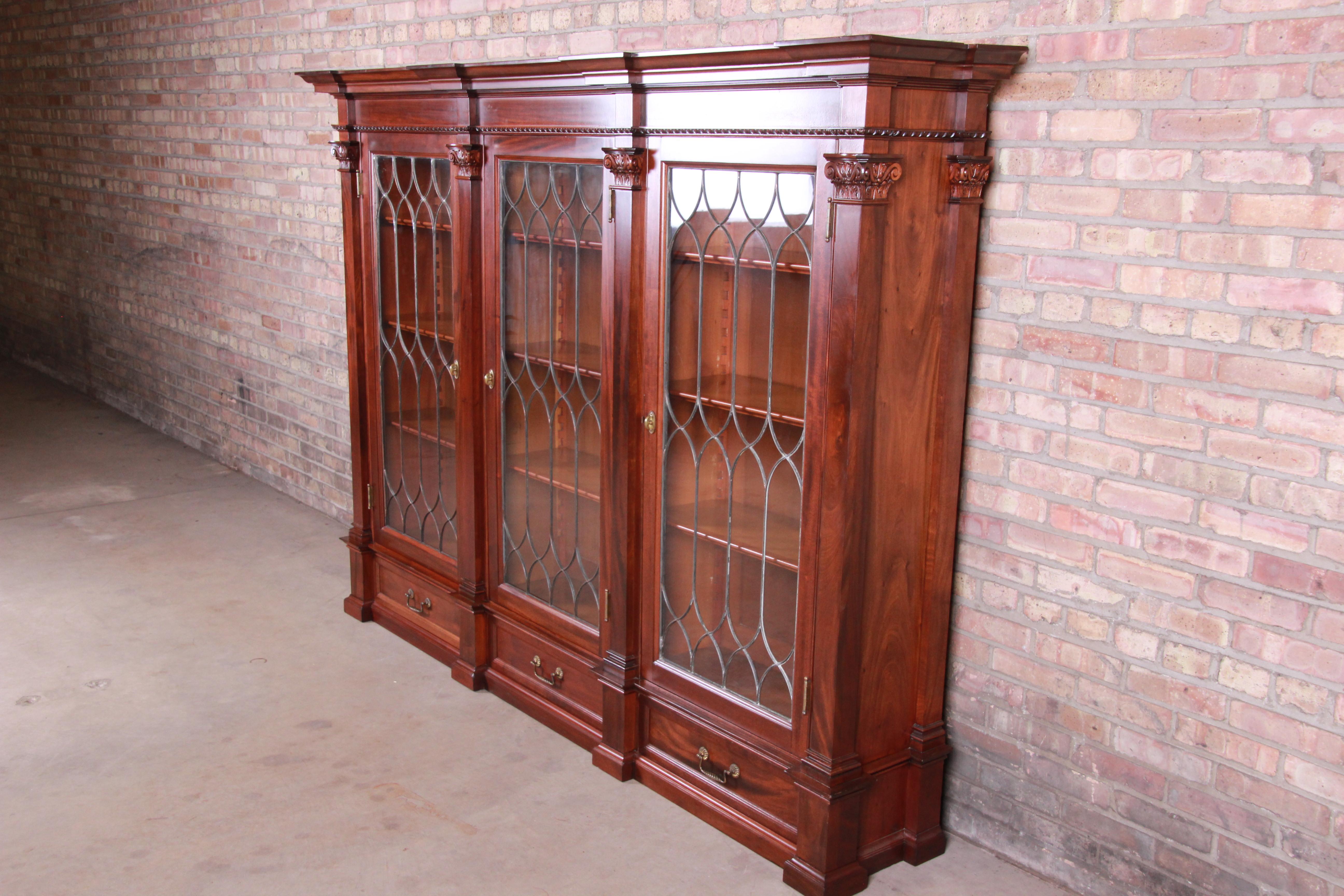 A rare and outstanding monumental antique Victorian triple bookcase

USA, circa 1860s

Solid carved mahogany, with leaded glass doors and original brass hardware.

Measures: 91.13