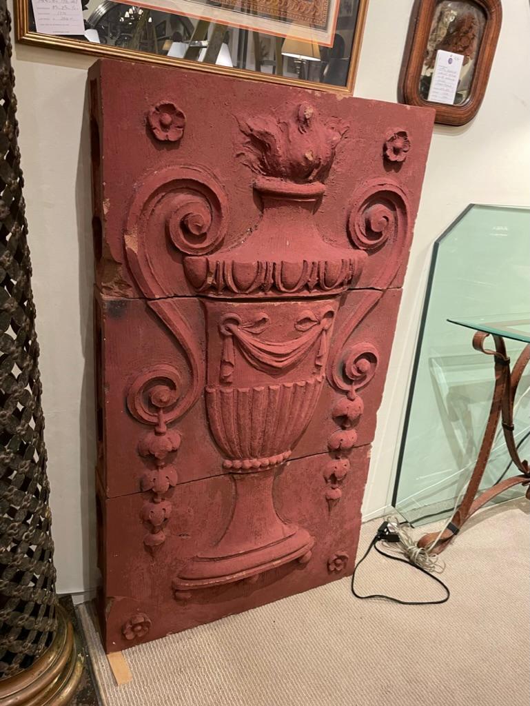 Wonderful large scale 19th century terracotta architectural decorative relief of a neoclassical style flaming two handled urn retaining the original red paint. The beautifully realized classical urn shown in deep relief with arabesque handles with
