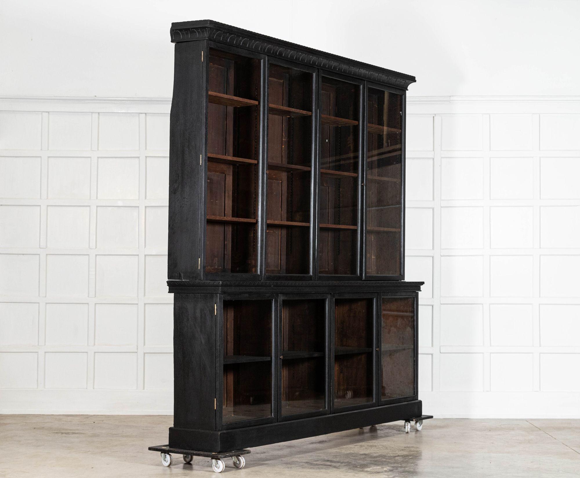 circa 1890
Monumental 19thC English Ebonised Oak Glazed Bookcase
sku 2068

Together W252 x D38.5 x H254 cm
Base W244 x D38.5 x H101 cm
Base internal shelf 32 cm
Top W252 x D33 x H153 cm
Top internal shelf depth 22cm
Weight 200Kg
Top 145kg
Base 55kg