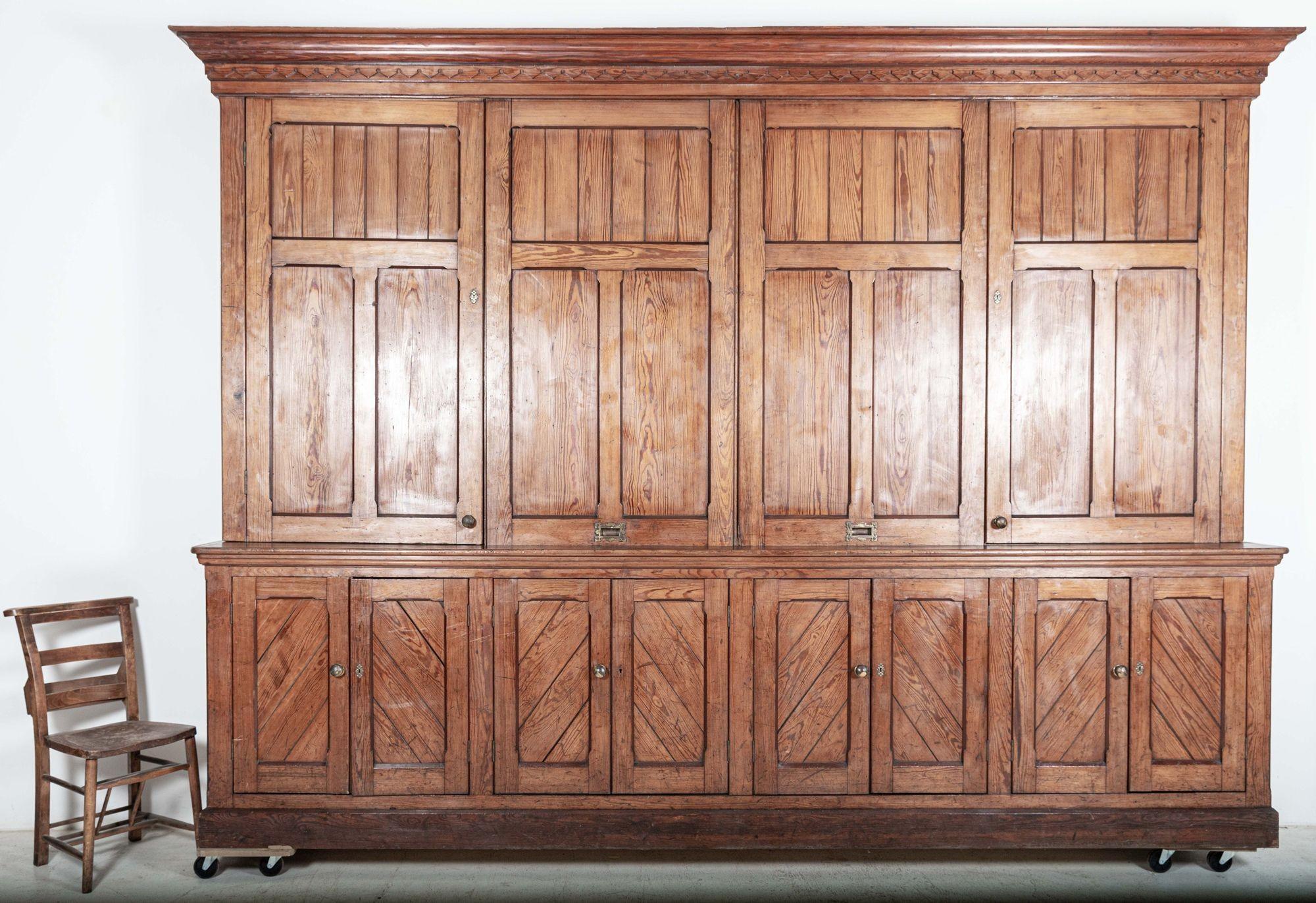 Circa 1870

Monumental 19thC English Pine Housekeepers Cupboard/ With two panelled central sliding doors, 2 outer hinged doors to the top cabinet and 8 Panelled doors to the base cabinet.

Two pieces top and base cabinet.

(Signs of past repairs to