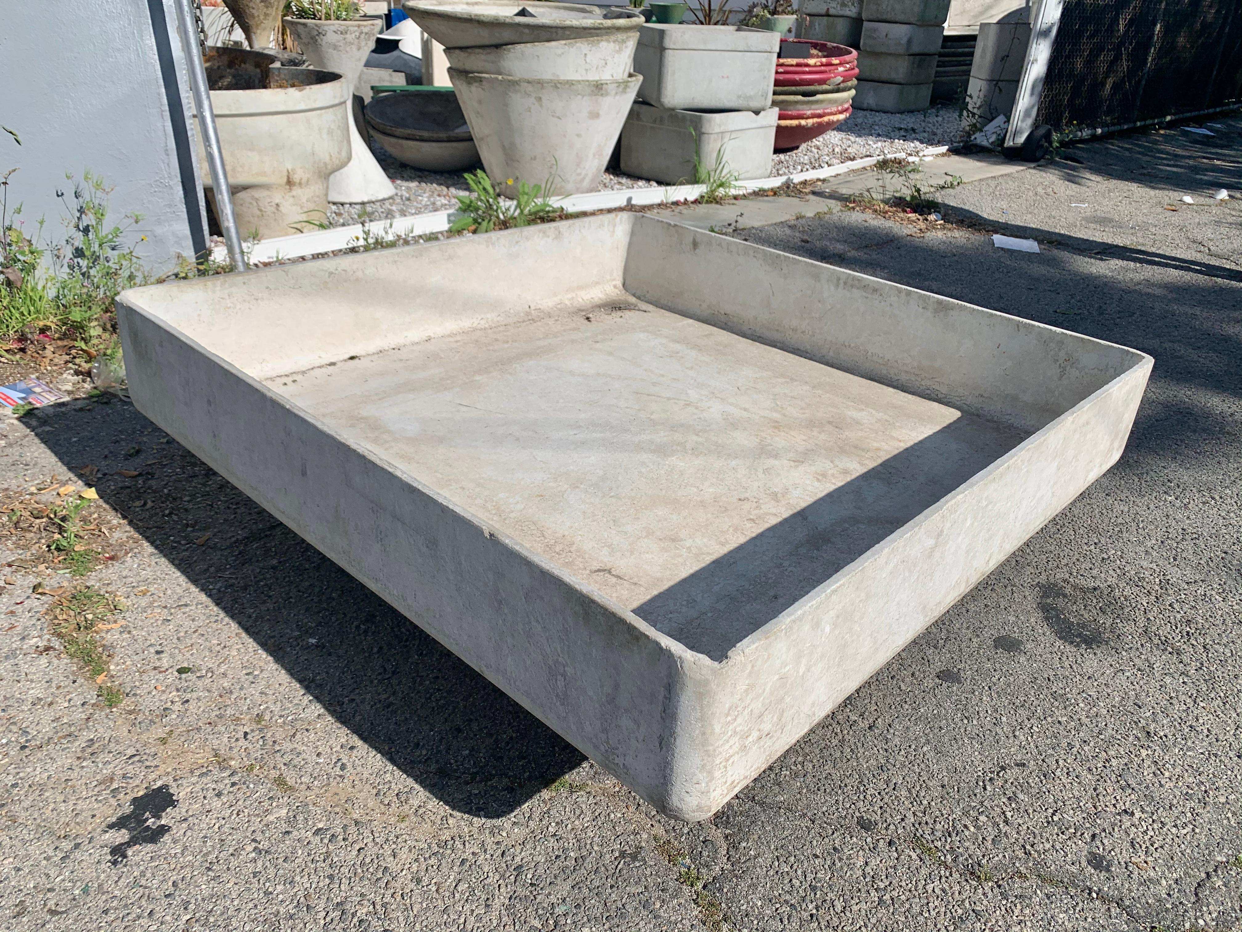 Impressive concrete sculptural pond/planter by Willy Guhl. Massive concrete square sits atop a smaller concrete square base. Could be used to accommodate a fountain, pond or plants. Good vintage condition and patina. Extremely rare piece of