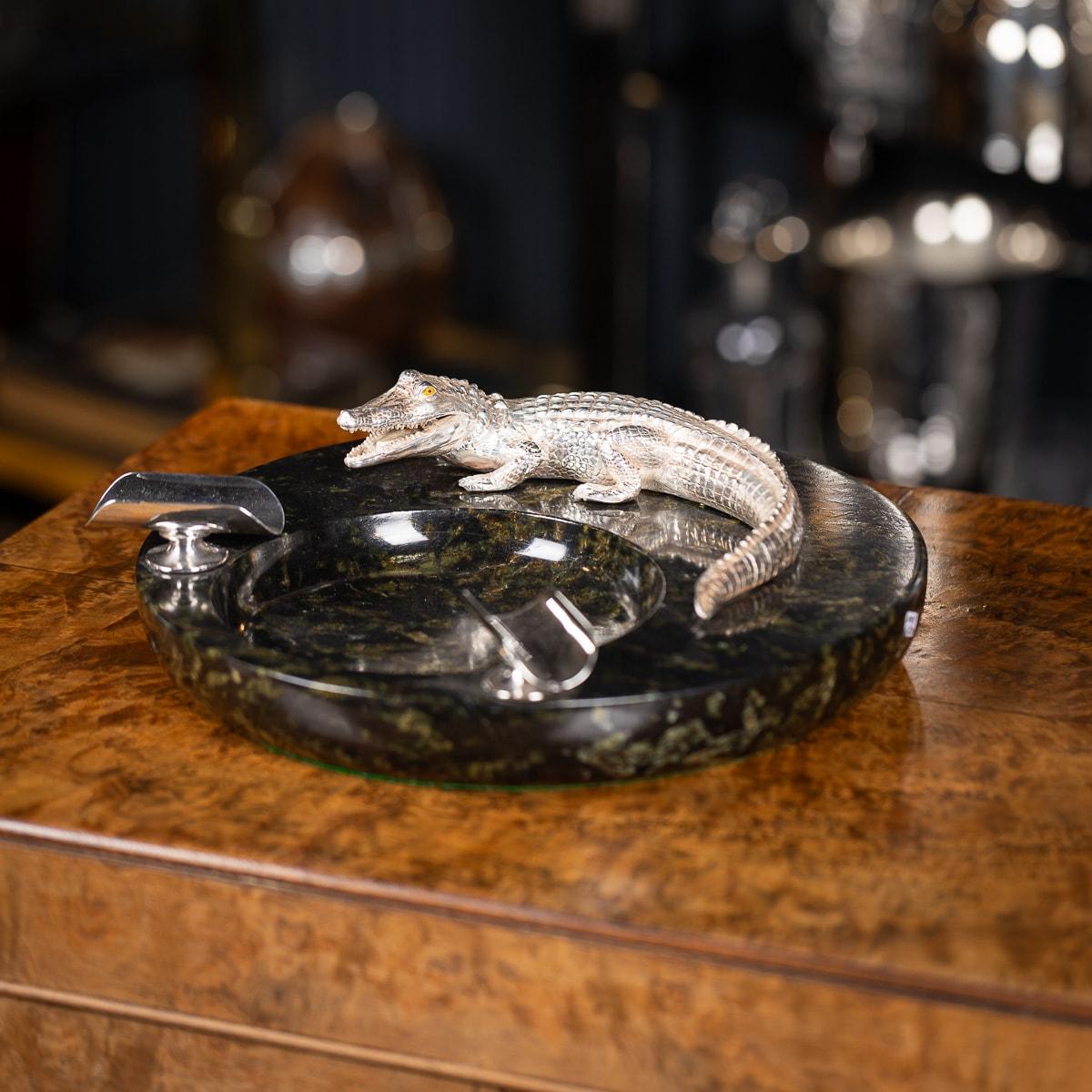 This monumental vintage ashtray from the late 20th century combines silver plate and mounted on Italian green marble. The centrepiece is a lifelike silver-plated crocodile, meticulously designed with fine details in the scales, teeth and eyes. The