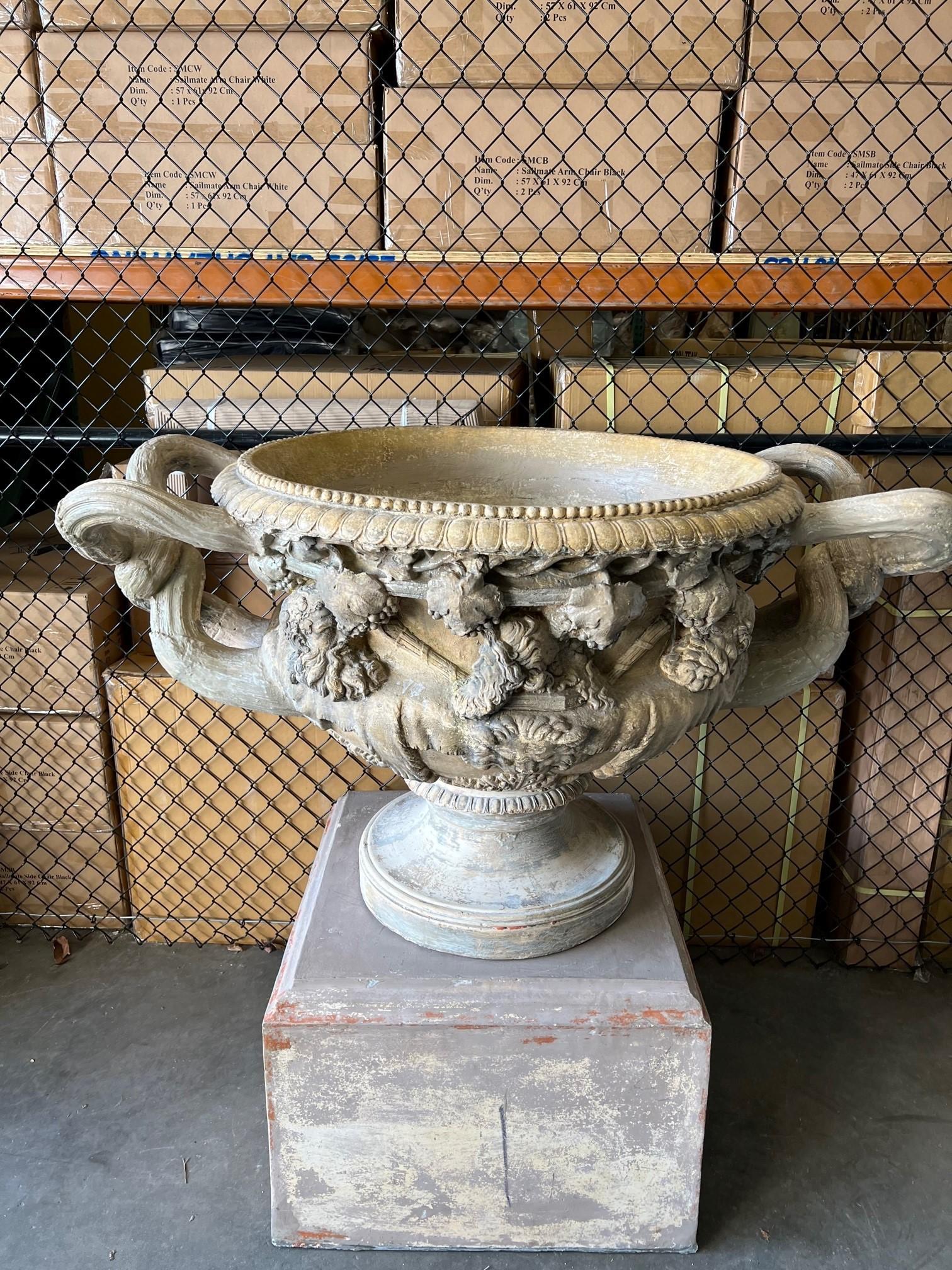 Monumental large decorative terracotta handle urn on a pedestal from London England. This is a wonderful urn with its large handles and amazing detailing its just fantastic. The pedestal measures 
27