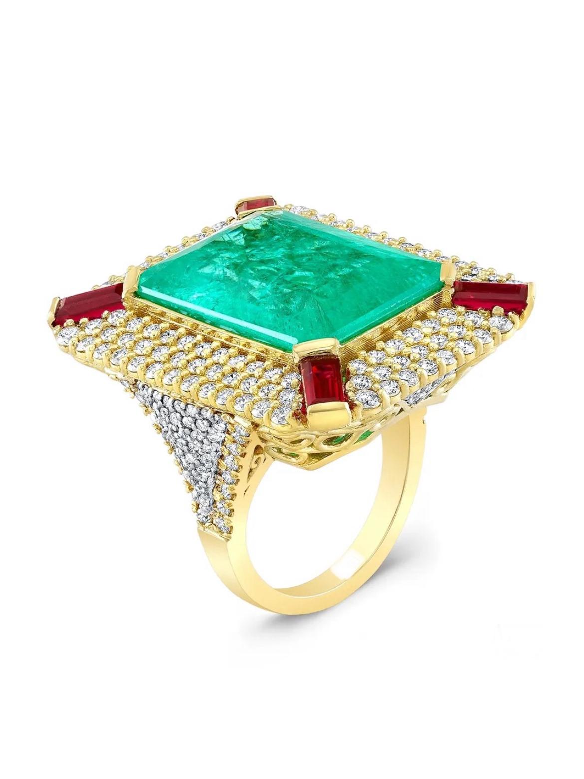 A monumental 23.06-carat untreated Paraiba-type Tourmaline from Mozambique is accompanied by a GIA report. It is framed within four Burmese Rubies weighing 1.89 carats and round diamonds weighing 2.97 carats. 