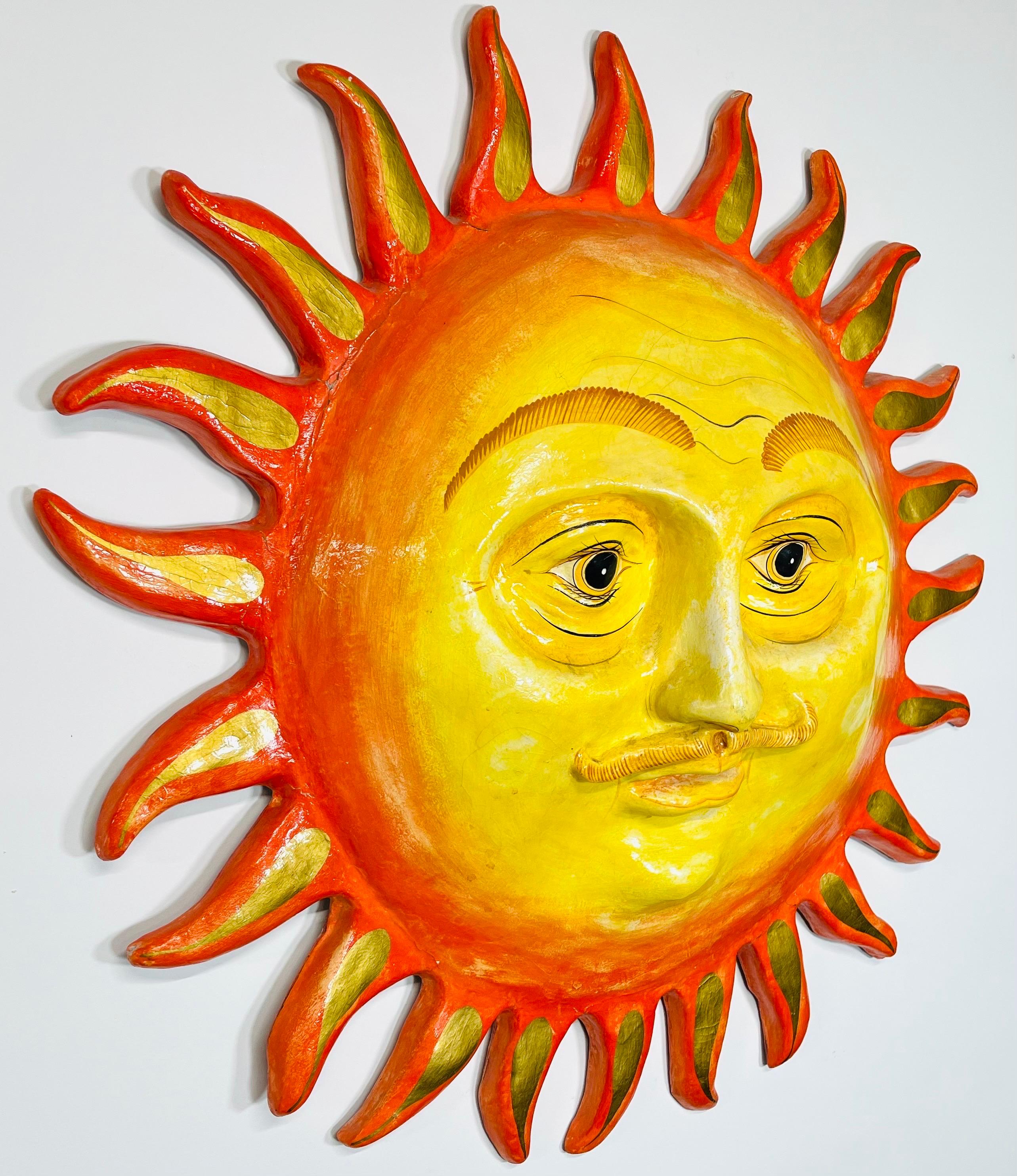 A delightful and fun wall sculpture titled “Smiling Sun” created in paper mache and hand painted by the artist. Attributed to Sergio Bustamante and imported from Mexico Circa 1970. 
In wonderful vintage condition having well maintained vibrant