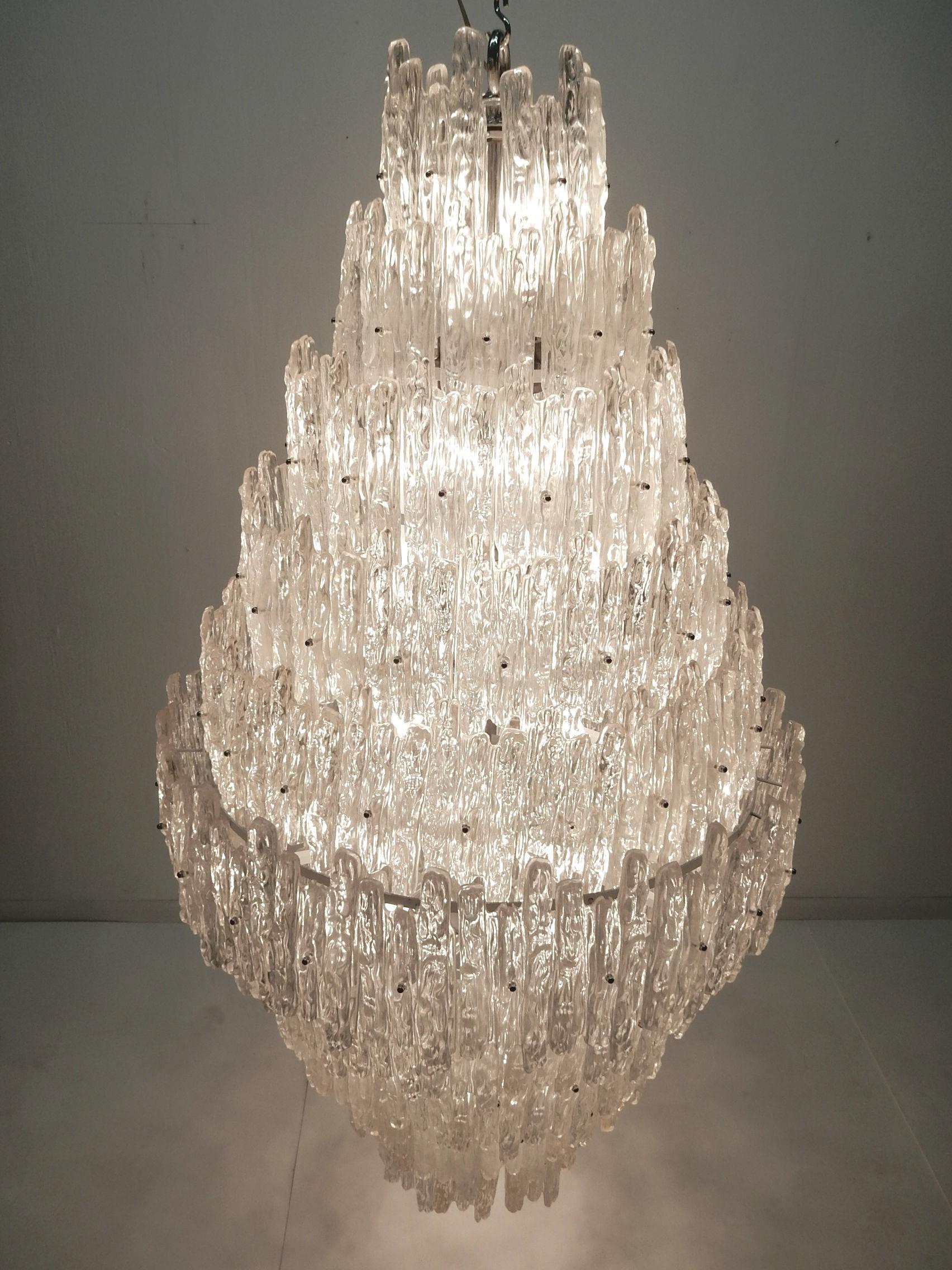 World’s largest? J.T. Kalmar style Lucite ice sculpture chandelier.
Contains 50 candle bulbs surrounded with 160 crystals suspended on a steel frame.
Huge piece measuring over 5 feet end to end. 
Judging by the construction it was custom made in the