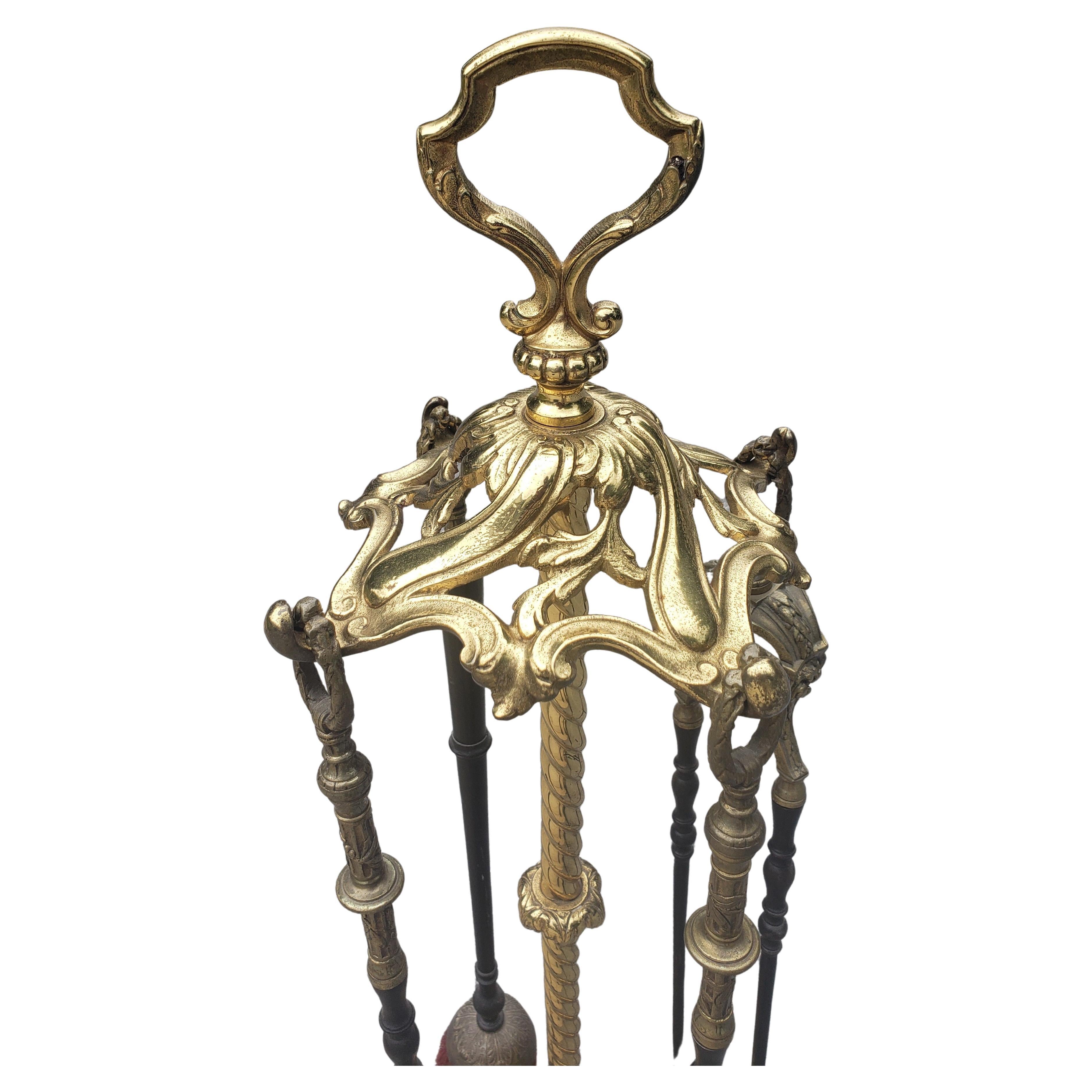 A monumental Louis XVI set of fireplace tools with stand. Extraordinarily crafted bronze stand will stand out in your fireplace decor. Comes with a complimentary primitive cast iron fireplace waffle maker in near perfect condition, unused.