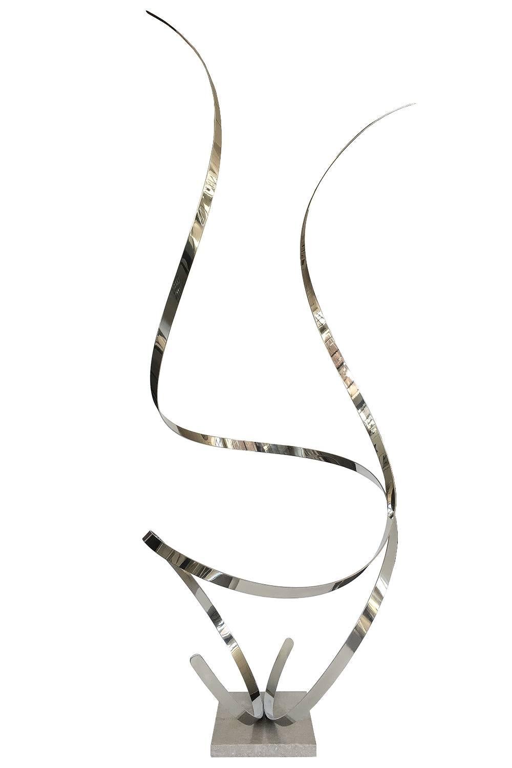 A monumental free-form ribbon floor sculpture by Philip Culbertson. Measuring 80
