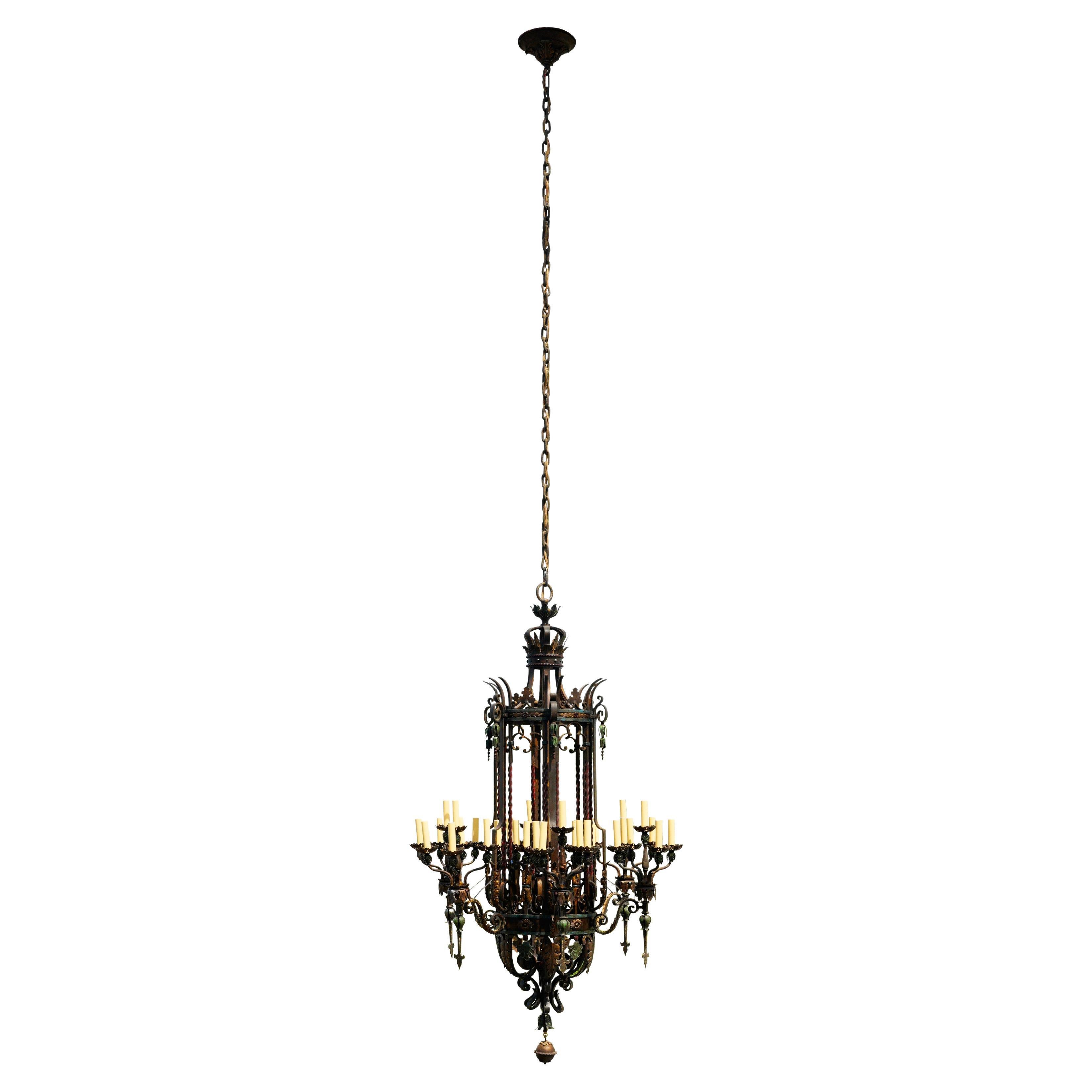 Large scale 36 light chandelier from The First National Bank in Huntingdon, PA. This chandelier is highly ornate and made of hand wrought bronze and iron and retains its original polychrome finish. It has been completely rewired and is all original