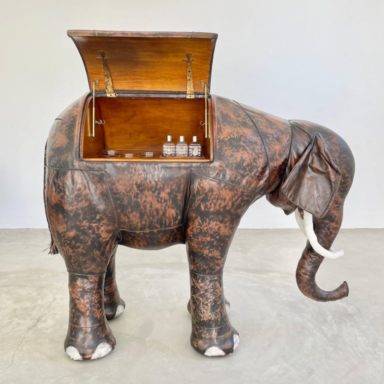 Incredible leather elephant bar by Dimitri Omersa for Valenti. Elephant torso opens up to built in bar. Wrapped in English cowhide, this piece was originally used in the 60s to outfit Abercrombie & Fitch stores when the company was an Omersa