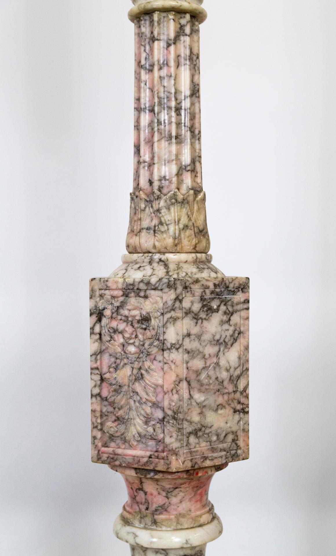 Alabaster and Pincanna marble floor lamp made in the early 20th century; hand carved green key motif and faces sculpted under the fluted column above the base. Some areas are rich pink. Beautifully veined and variegated with stone. Newly rewired,