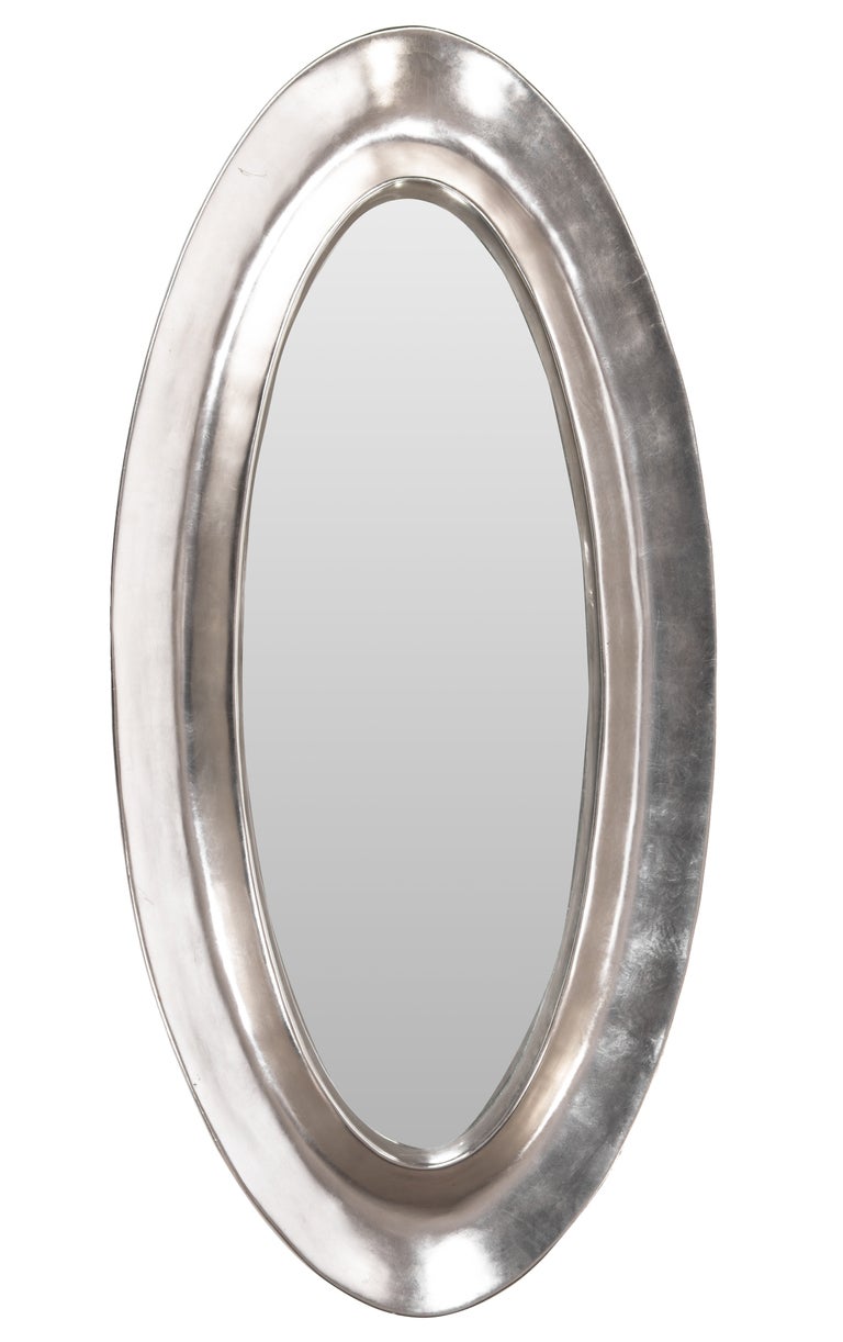 Monumental oval hand cast plaster mirror with applied aluminum leaf.
Handmade by artist Lawrence De Martino, circa 1990s.