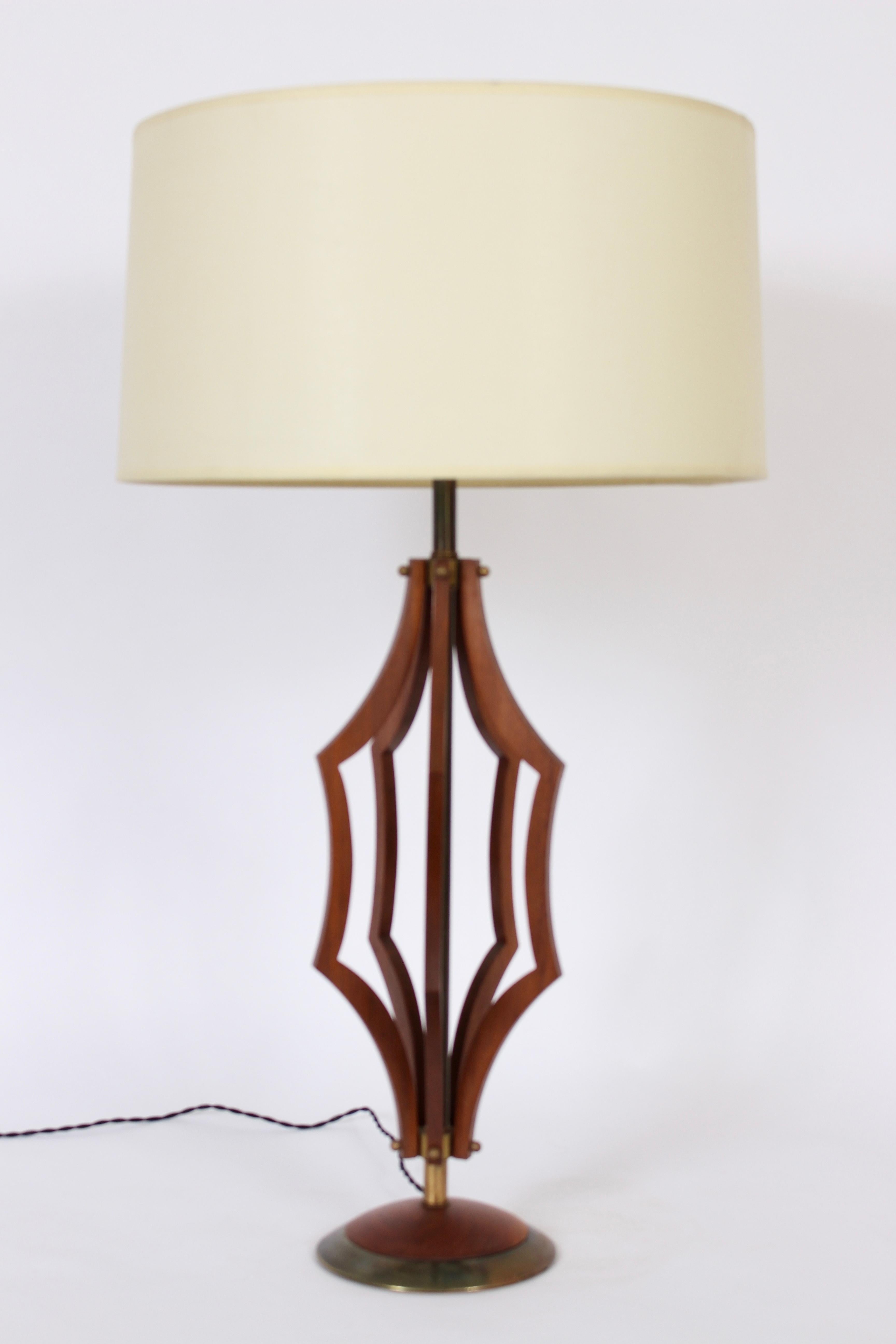 Tall Modernist walnut table lamp with Hexagonal flared framework and brass detail. Featuring an open and joined six piece Walnut framework. With Walnut base and patinated Brass inset. 34H to top of finial with harp in place. 27H to top of socket.