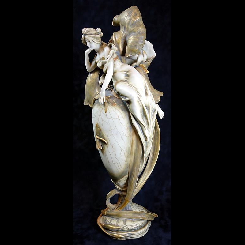 Monumental, museum quality signed Amphora porcelain vase with maiden atop an iris clad vessel with dragonfly and web motif in an Art Nouveau design dating from circa 1900. Vase is hand painted and signed on the underside RS&K (Reisner Stellmacher &