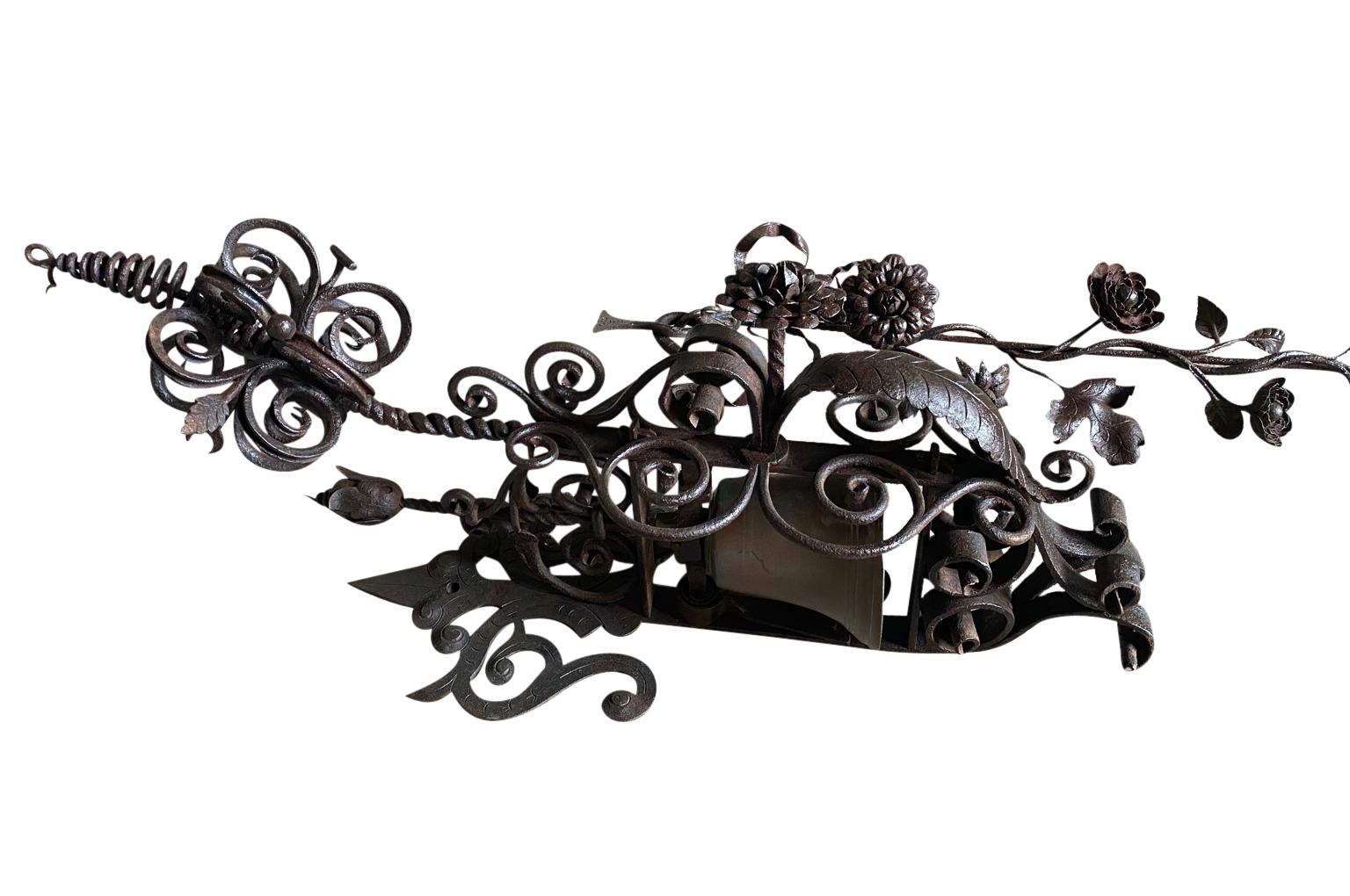 A monumental and exceptional early 19th century Door Bell Pull from the South of France.  Magnificently crafted from iron with stunning floral motifs and its bronze bell.  A very rare piece indeed. 