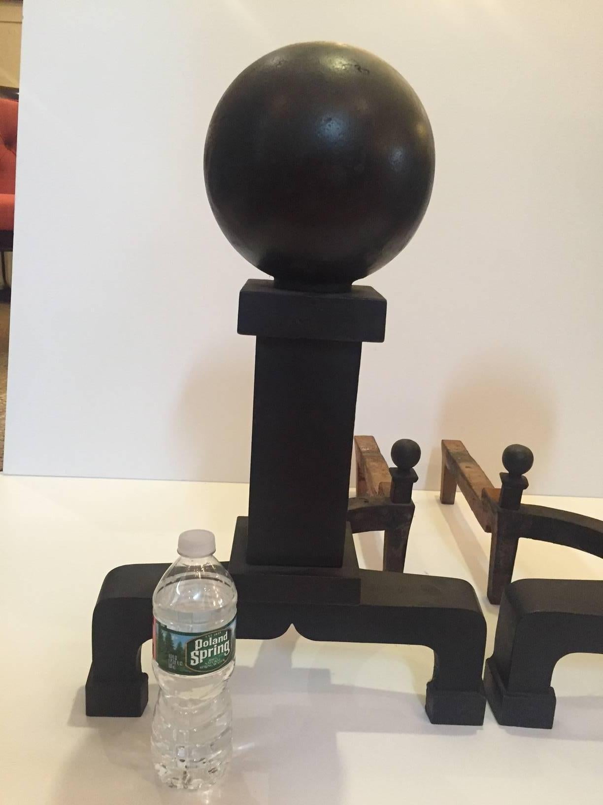 Impressive in scale, masculine and gutsy pair of black iron cannonball and irons.
There are little ball finials on the back that echo the monumental ones in front.
See how massive these are in size as shown in relation to the water bottle in one