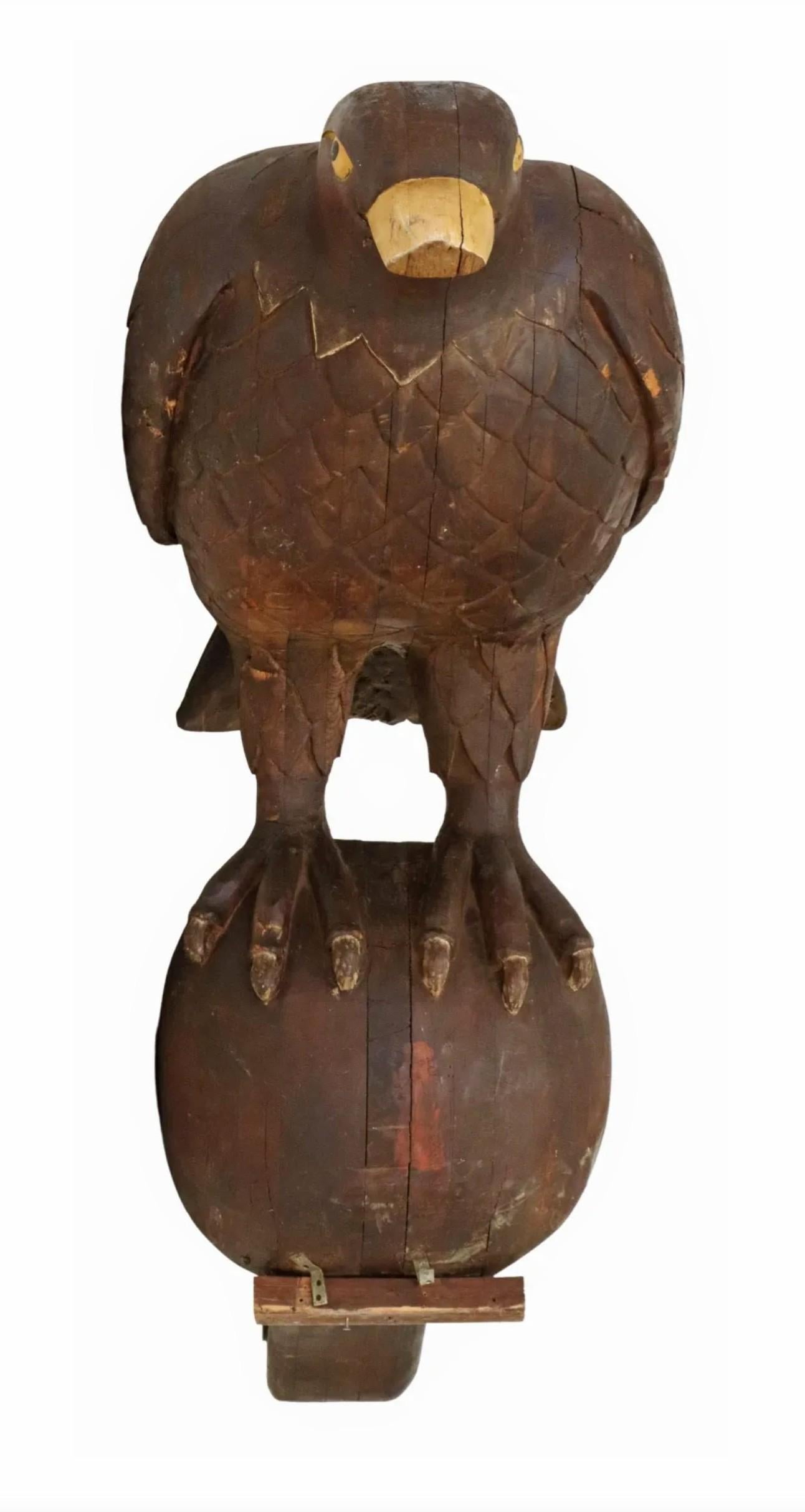 I think it's safe to say you have never seen a bird this big before!

A rare, nearly 8ft tall, one-of-a-kind antique architectural hand carved wood sculptural element, in the form of an eagle, with yellow painted beak and eyes, having closed