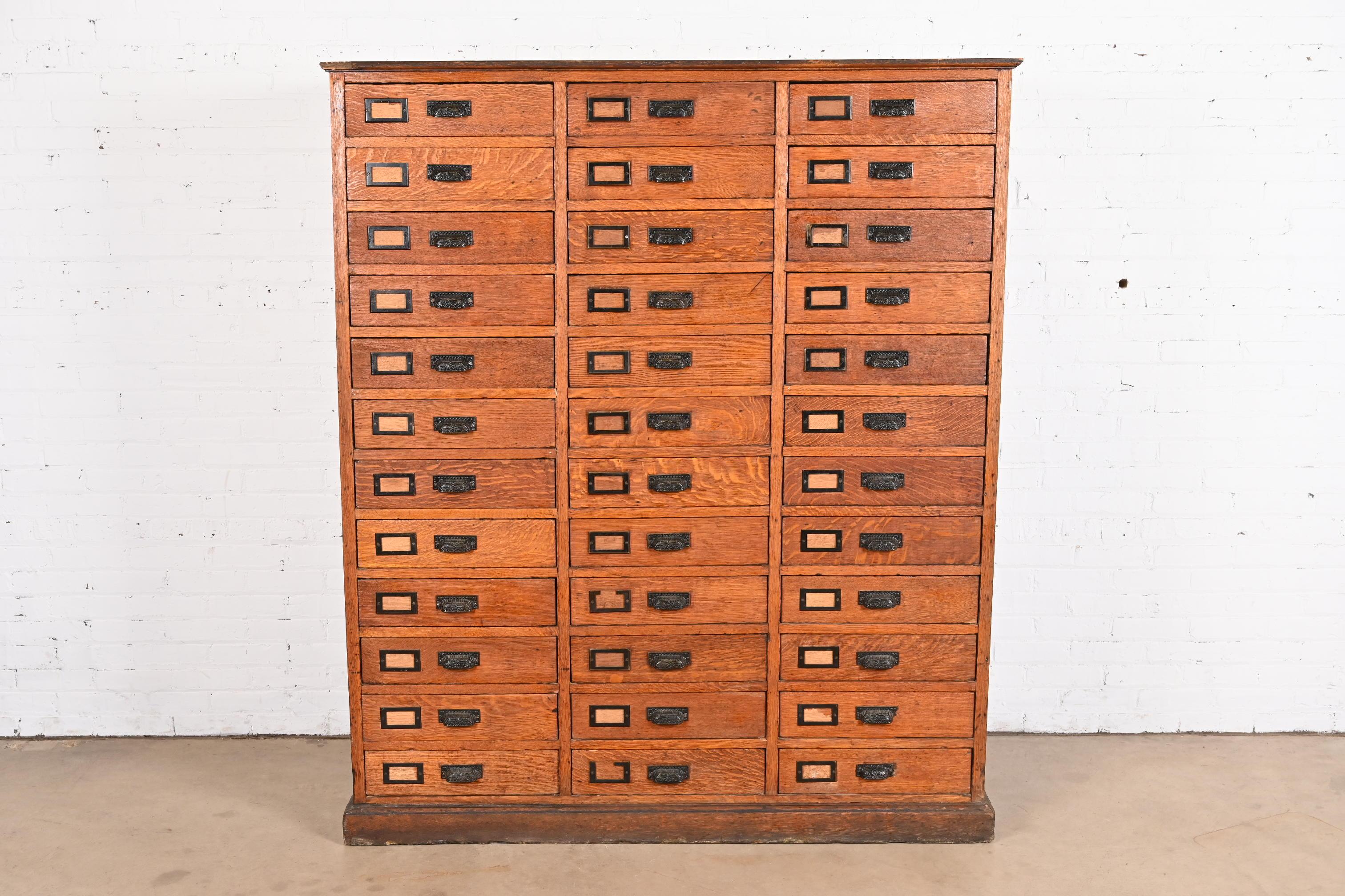 A rare monumental antique Arts & Crafts or Late Victorian 36-drawer file cabinet or chest of drawers

USA, Circa 1900

Solid quarter-sawn oak, with iron hardware.

Measures: 59.5