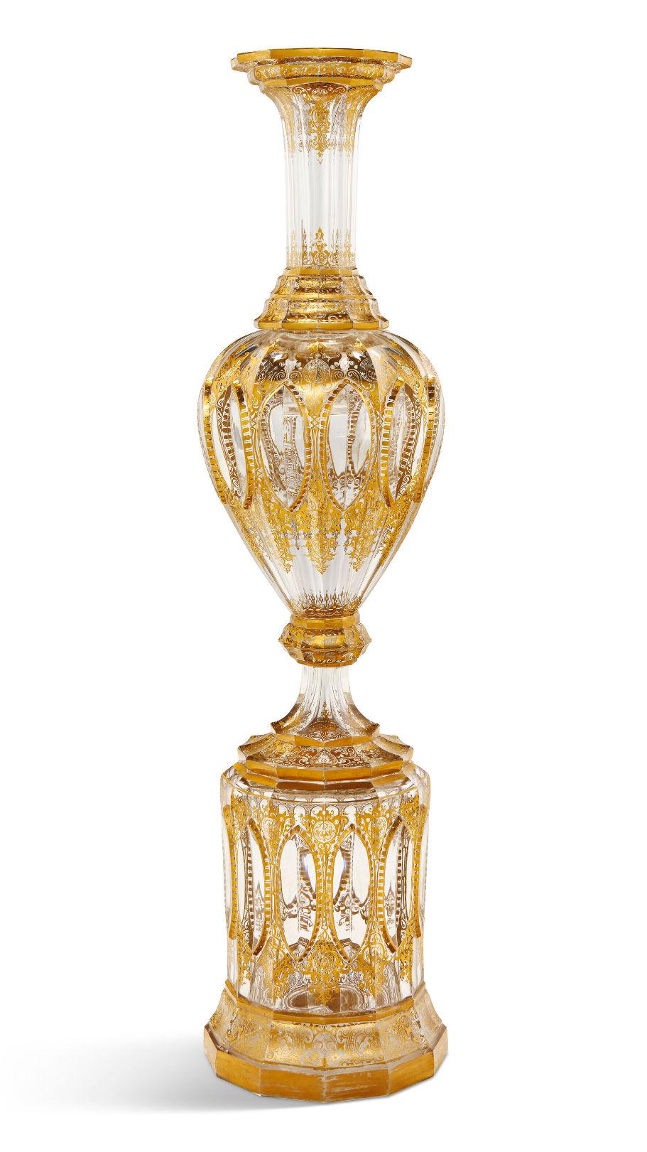 Our very large (33 1/2 inch tall) and elegant gilt-decorated glass vase on stand dates from the third quarter of the 19th century. Attributed by a leading international auction house to Wilhelm Hoffman (1808-1866) of the Harrach glassworks in