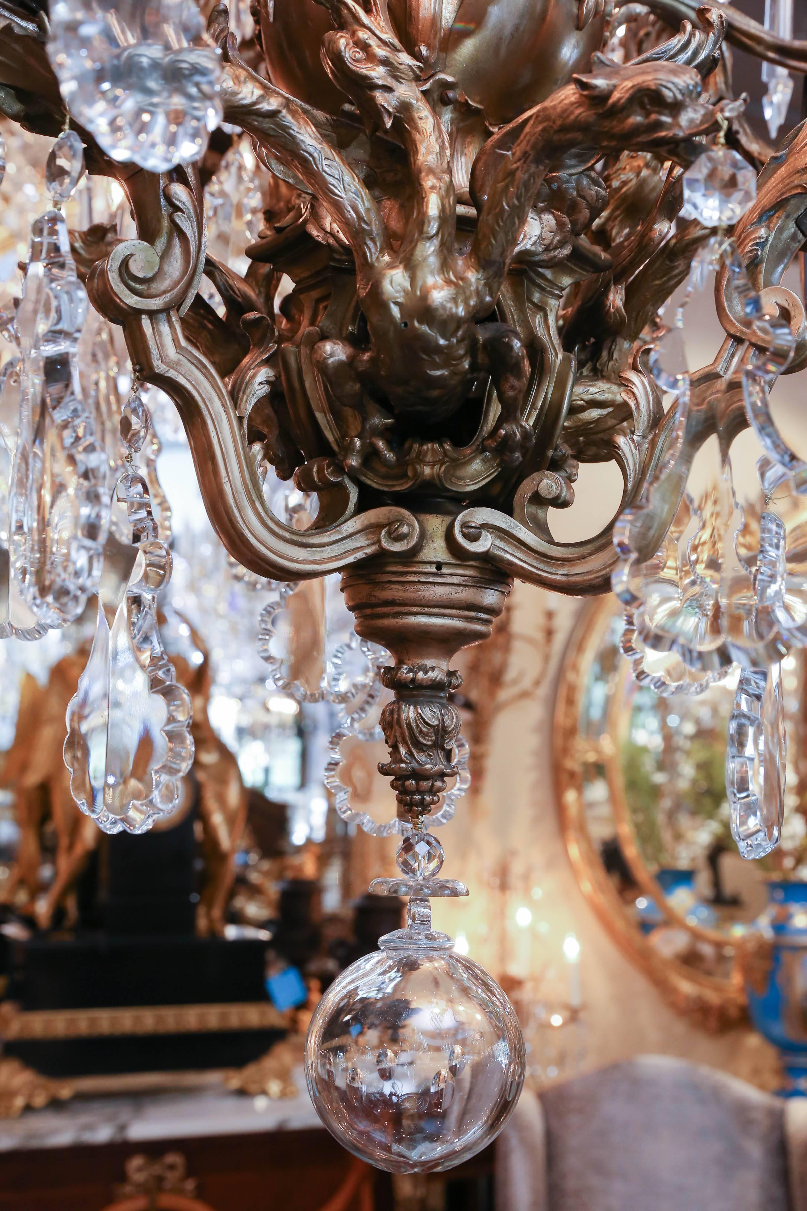 Scrolling arms with mounted winged putti, foliate forms
And winged griffins, wired beautiful large scale crystal
With notched crystal on the bobeches
Antique bronze with original patina.